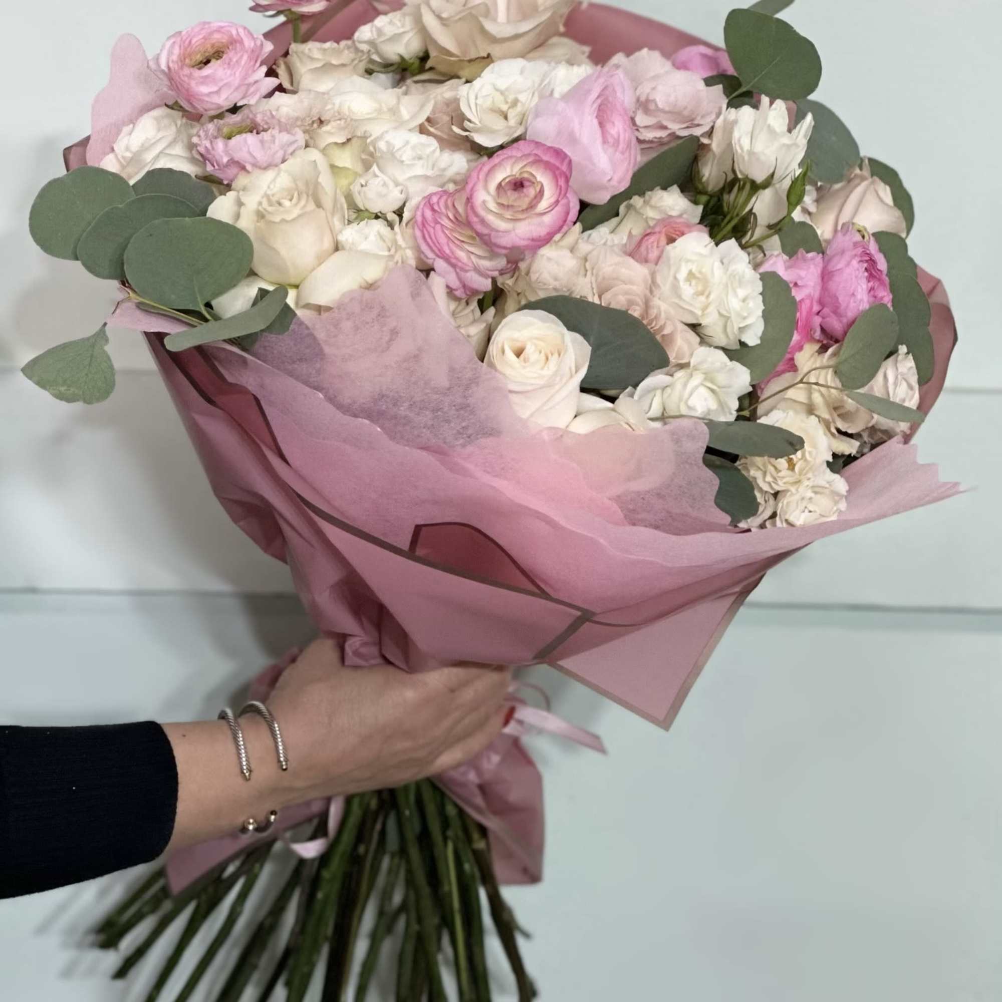 Overflowing with ranunculus, lisianthus, and roses in soft pinks and creams, this
