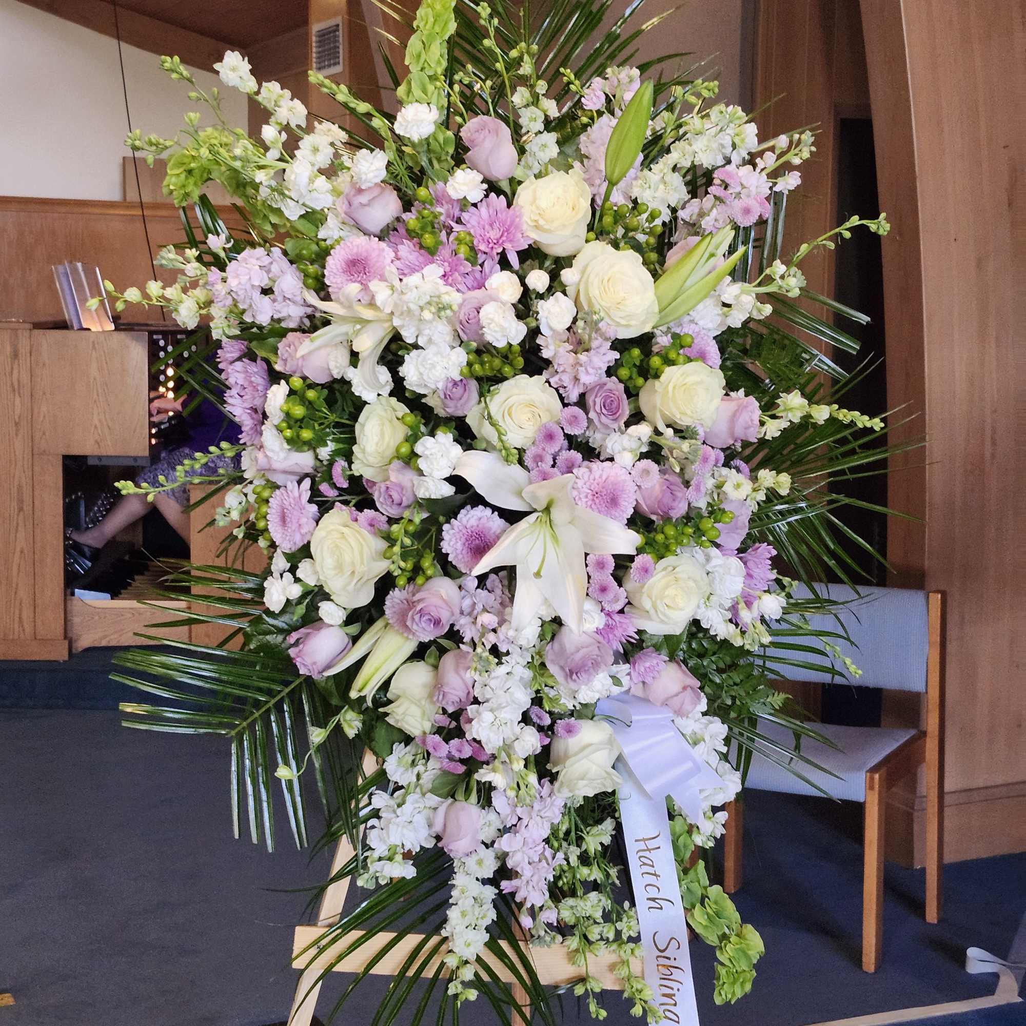 Lavender Funeral flower Spray arrangement filled with roses and many more beautiful