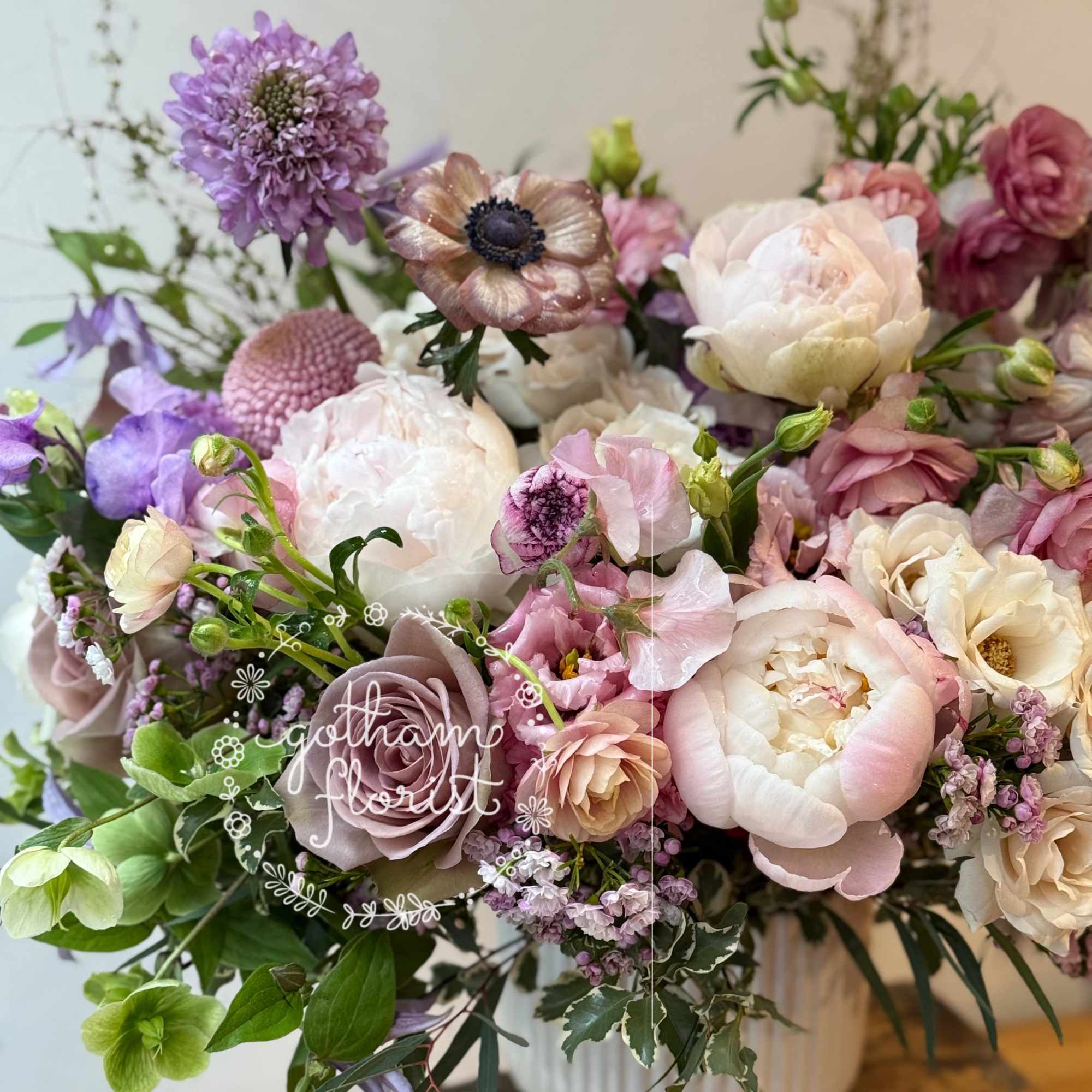 Soft lavender and purple flowers in rustic tin vase. Send unique, gorgeous
