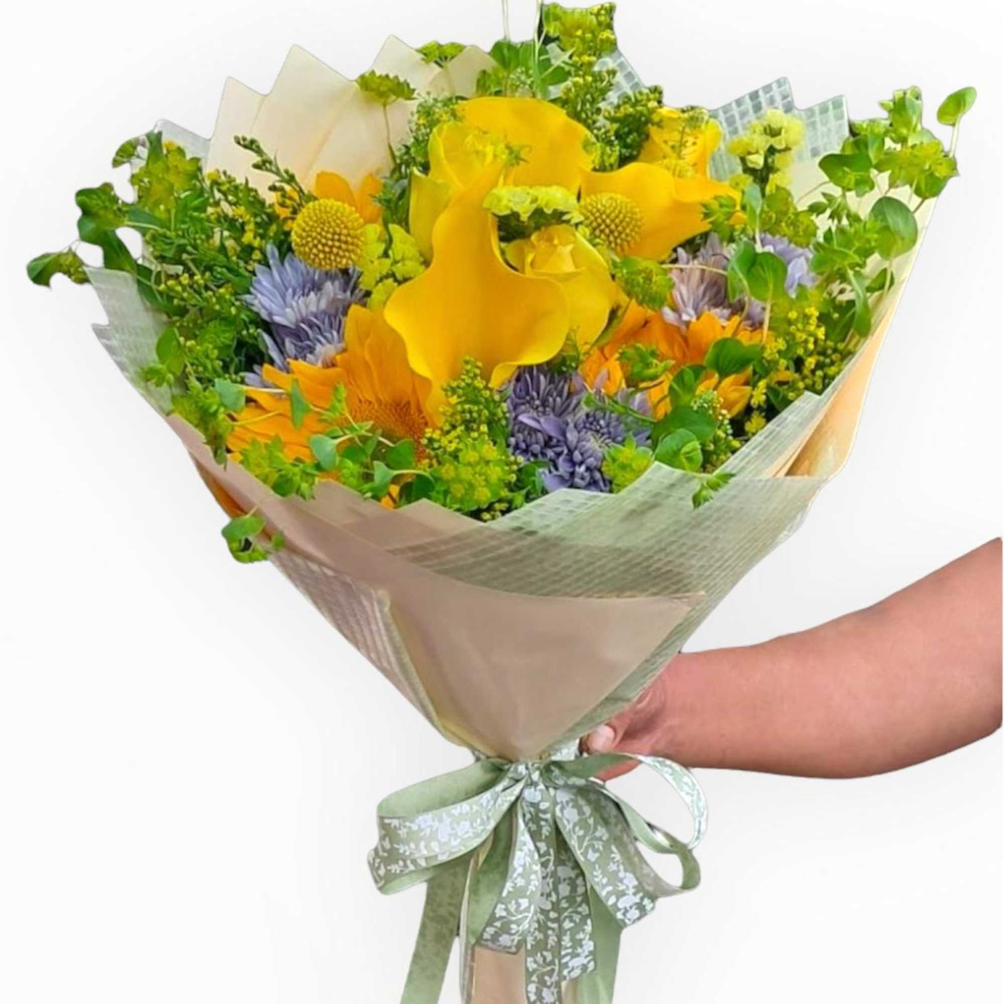 This wonderful wrap bouquet has sunflowers, calla lilies, roses, craspedia, lavender color