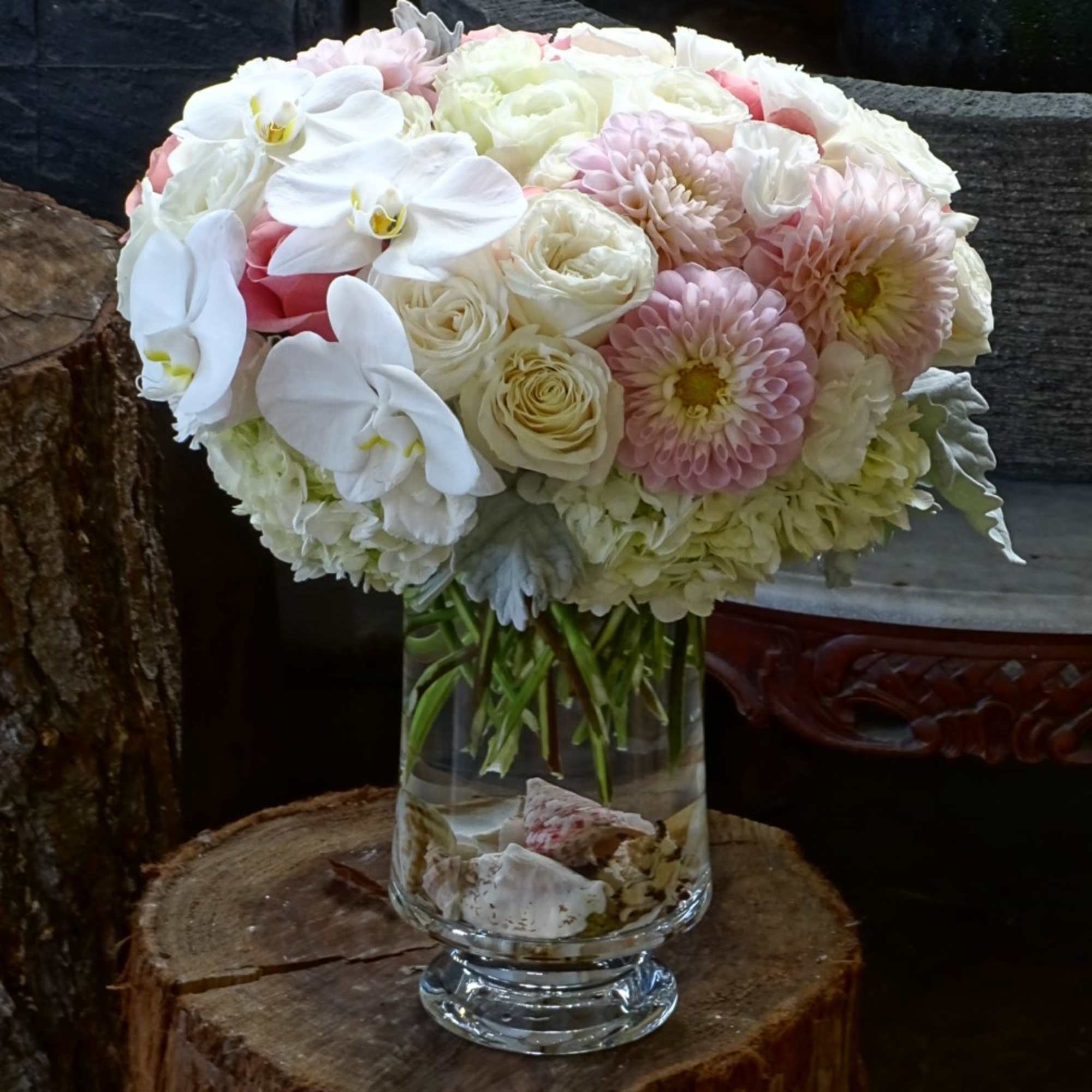 Premium Roses, Orchid, Hydrangea, and ....in glass vase design by sea shells