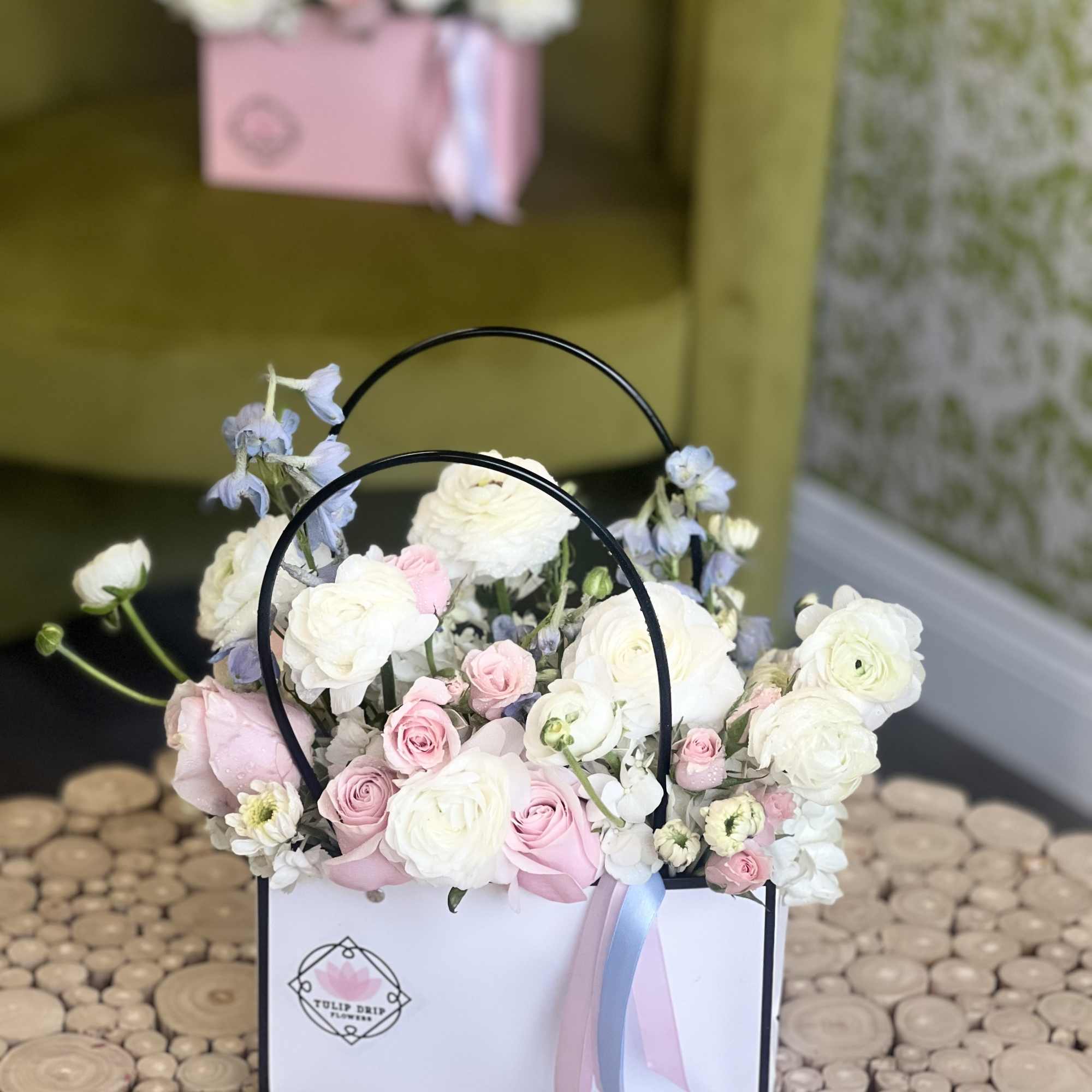 Roses, Hydrangeas, Ranunculuses in a paper bag. 