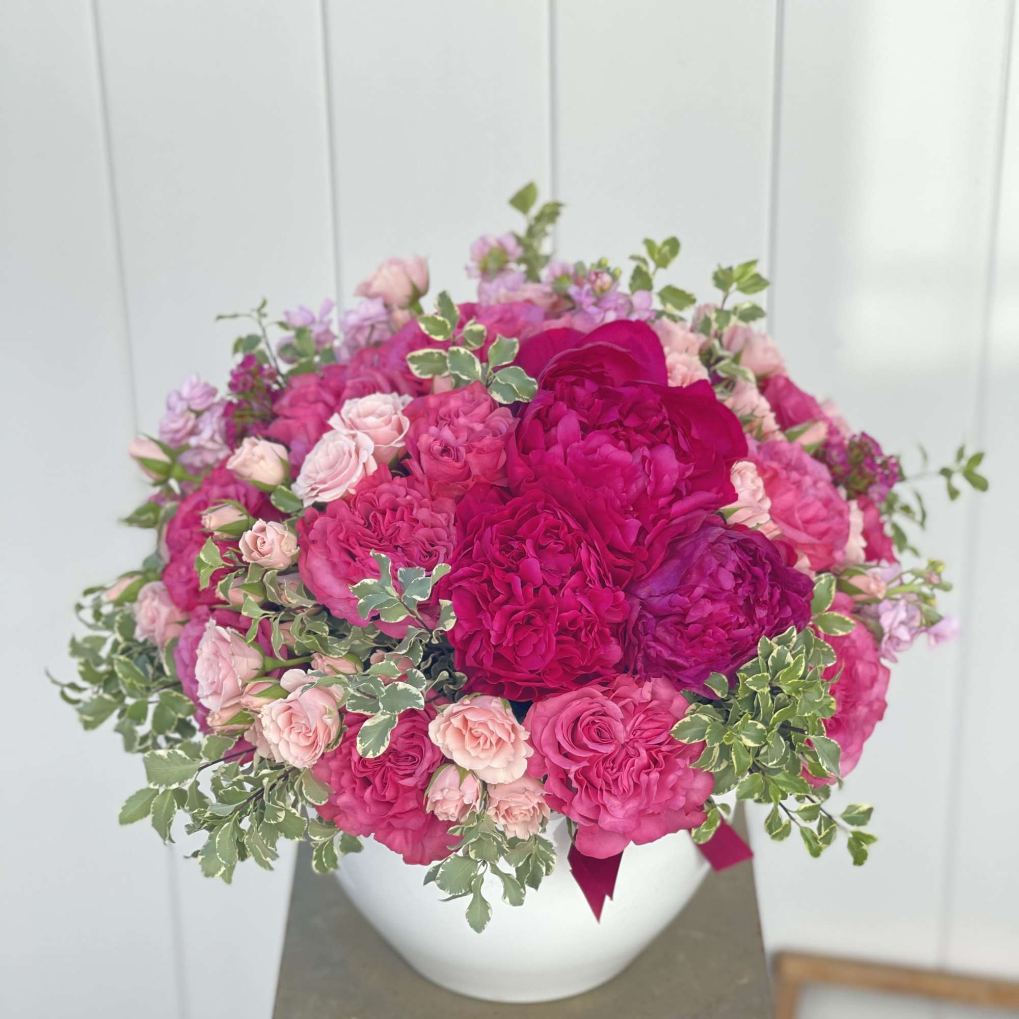 Composed of gorgeous ruffled fuchsia garden  roses alongside blush pink spray Composed of gorgeous ruffled fuchsia garden  roses alongside blush pink spray