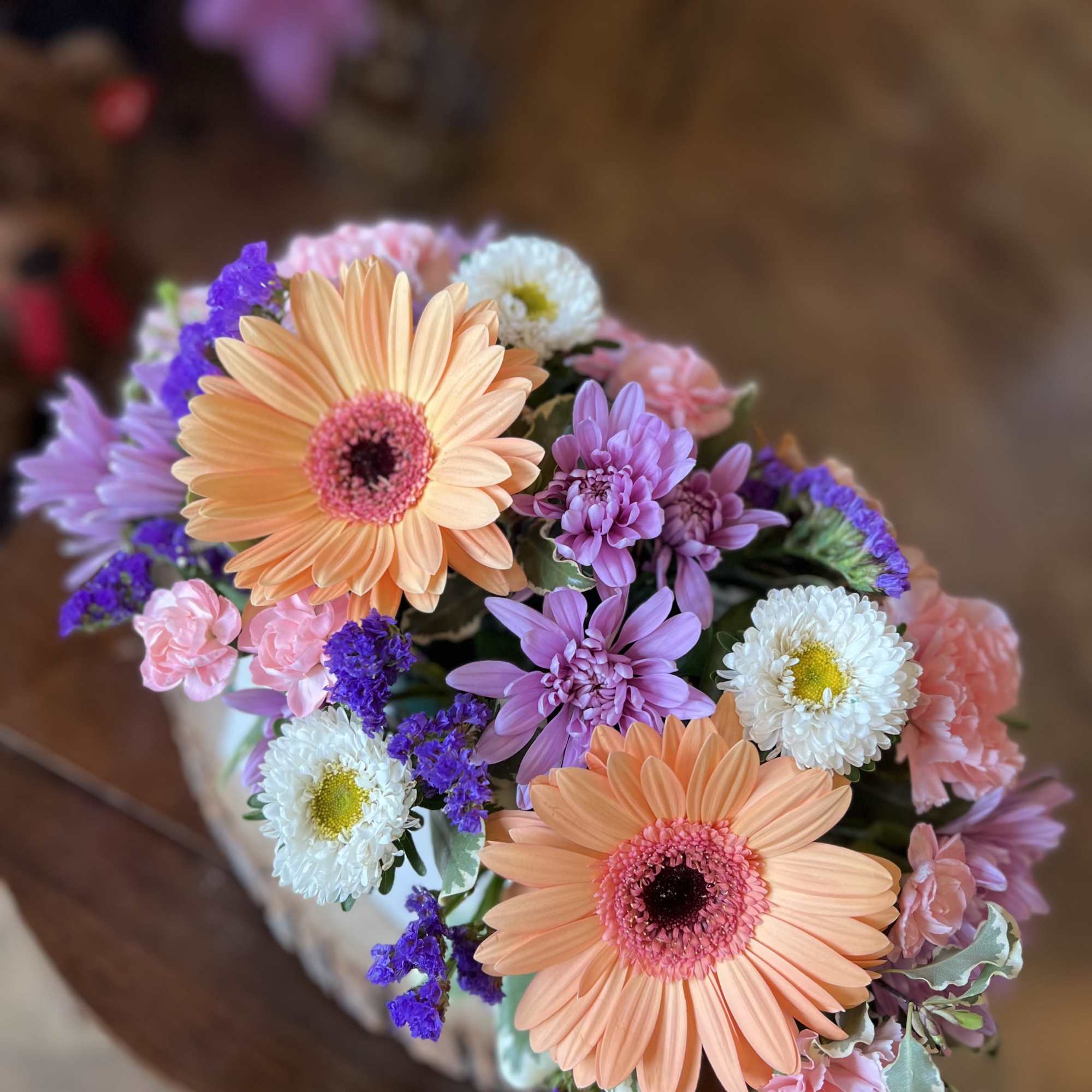 This uplifting box arrangement contains gerber daisy&rsquo;s, statice, cushion poms, asters, and