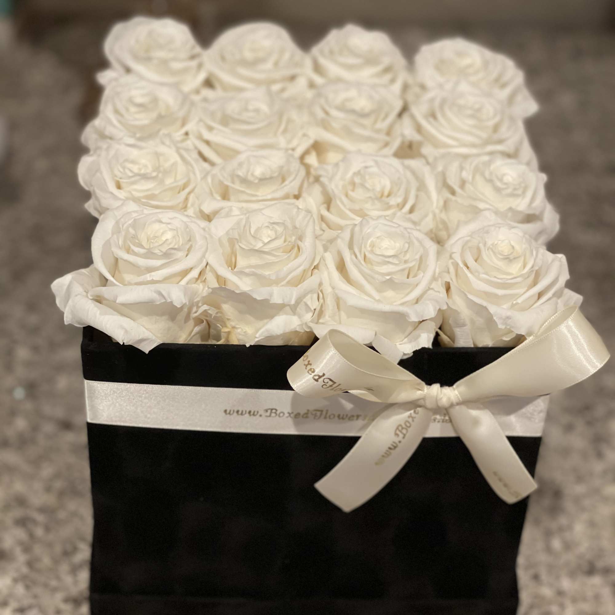 Black square box filled with 16 white everlasting roses. 
You can change Black square box filled with 16 white everlasting roses. 
You can change