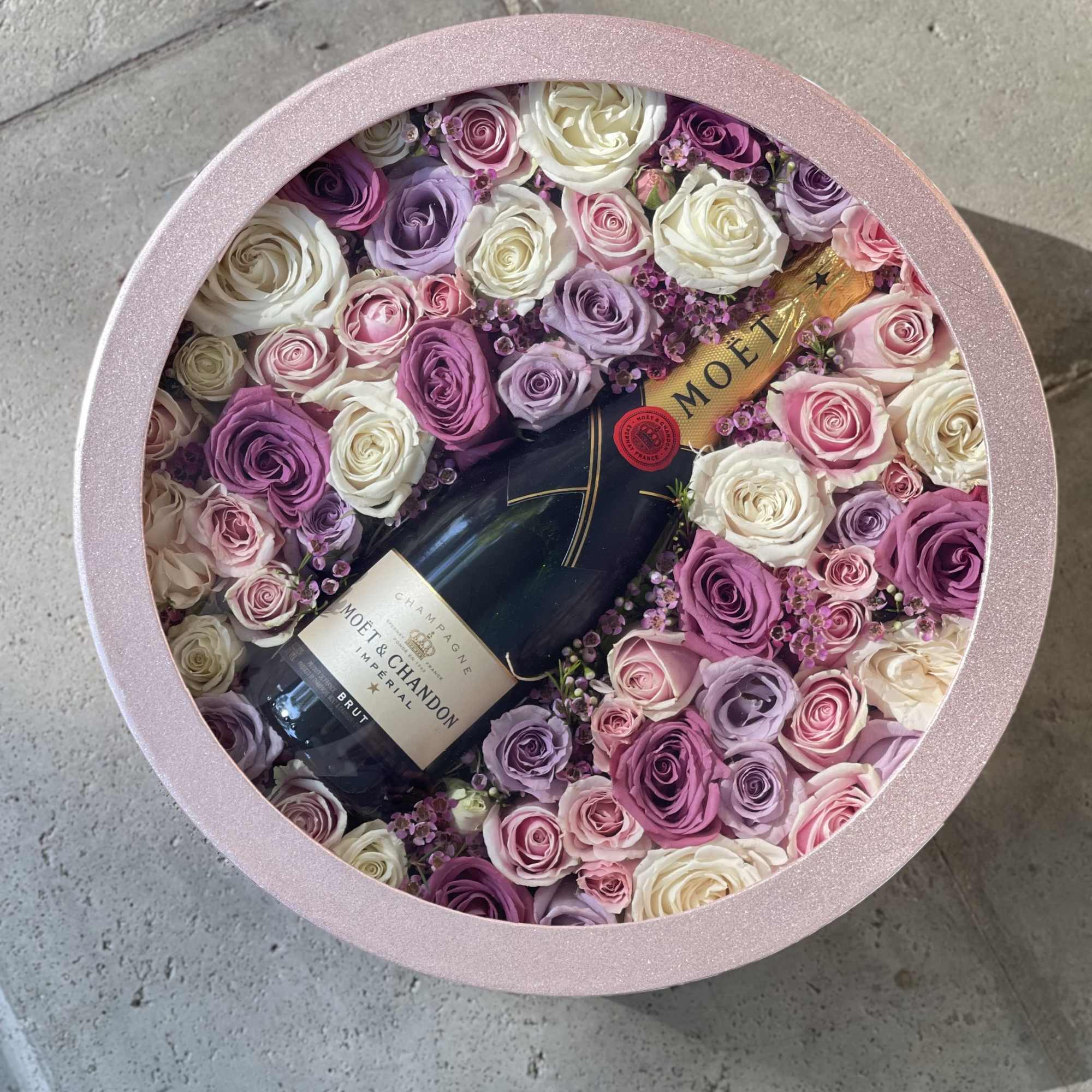 Full size Moët champagne accompanied with a combination of pink, lavender and Full size Moët champagne accompanied with a combination of pink, lavender and