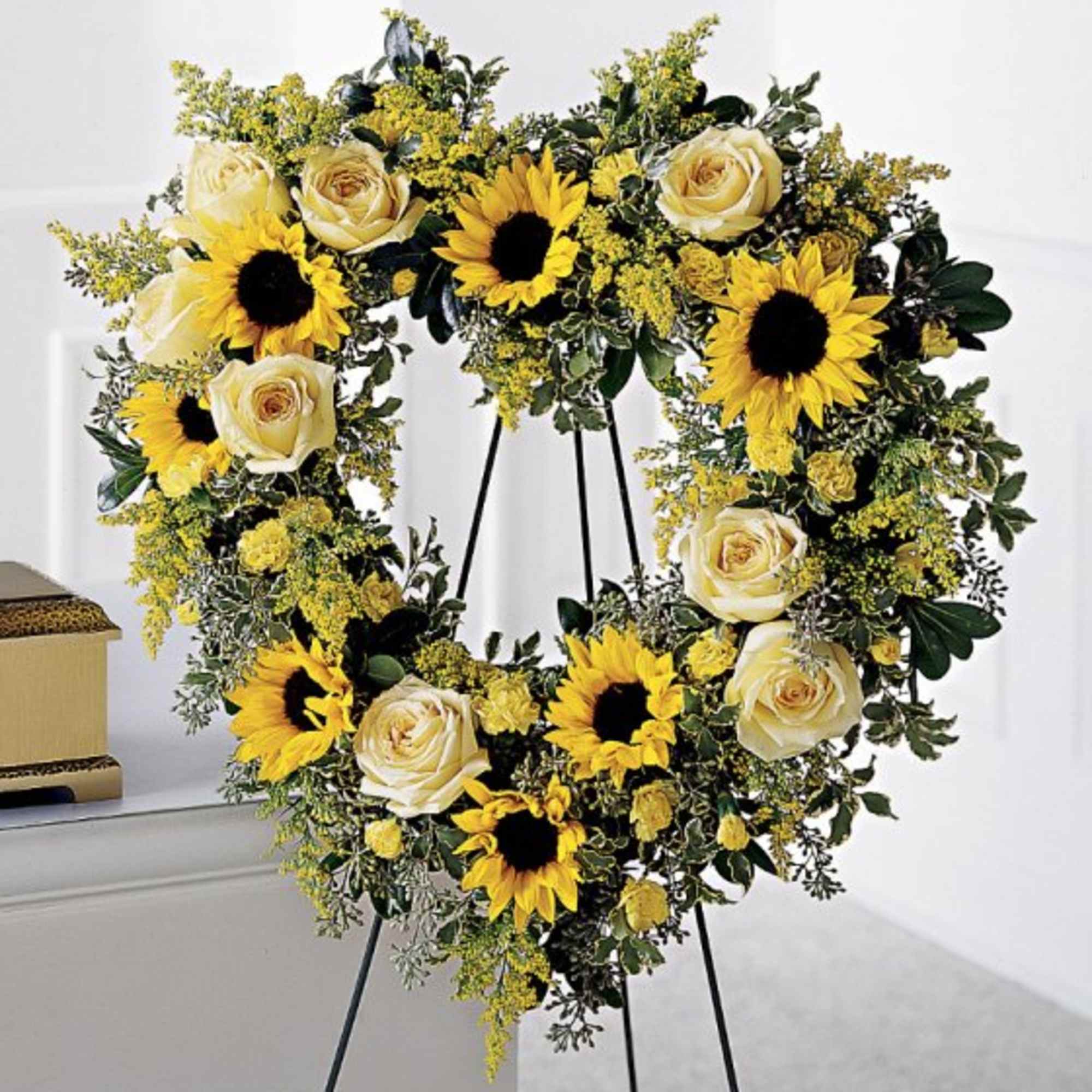 Sunflowers, roses, solidado and seeded eucalyptus standing spray.