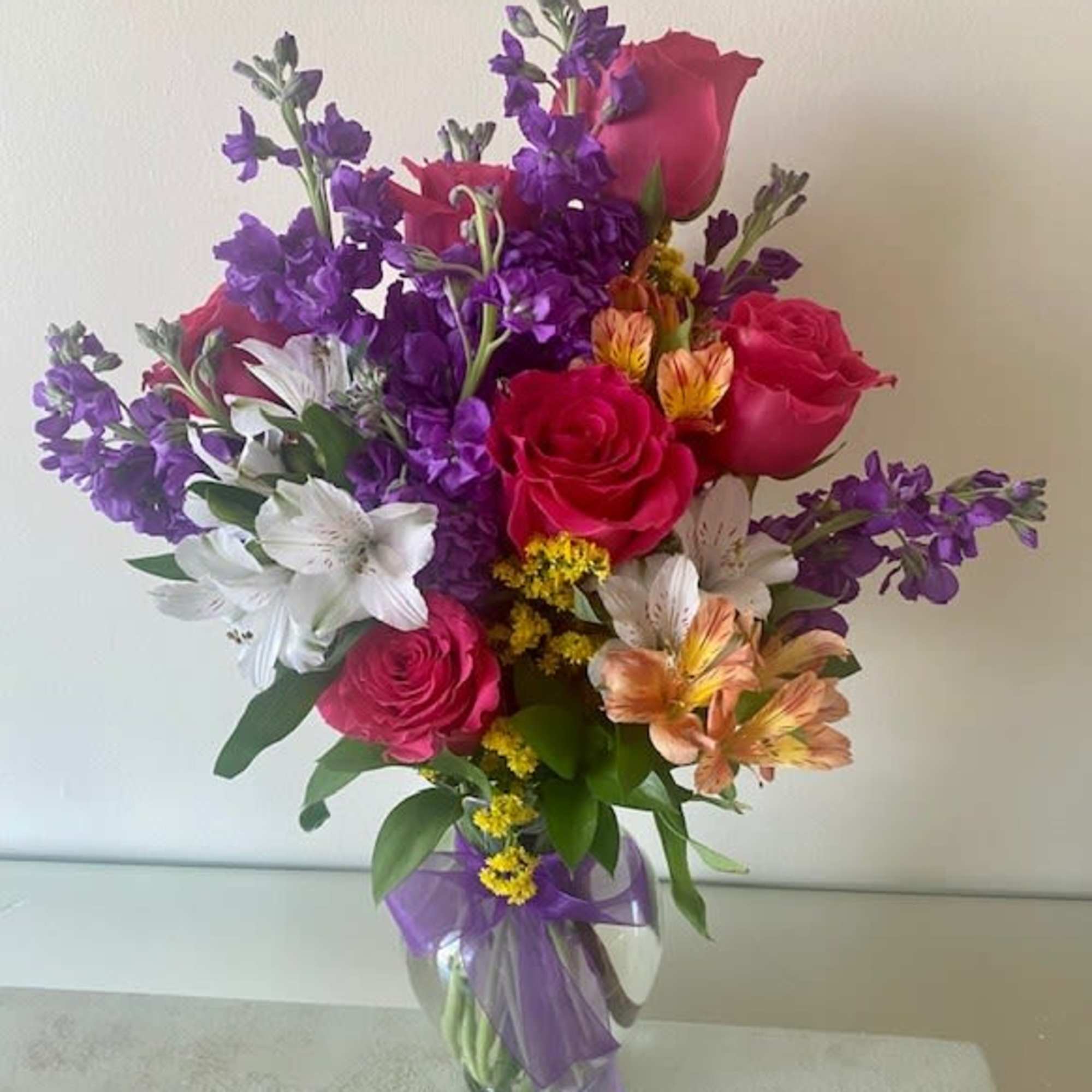 Mix of flowers arranged in a vase.
