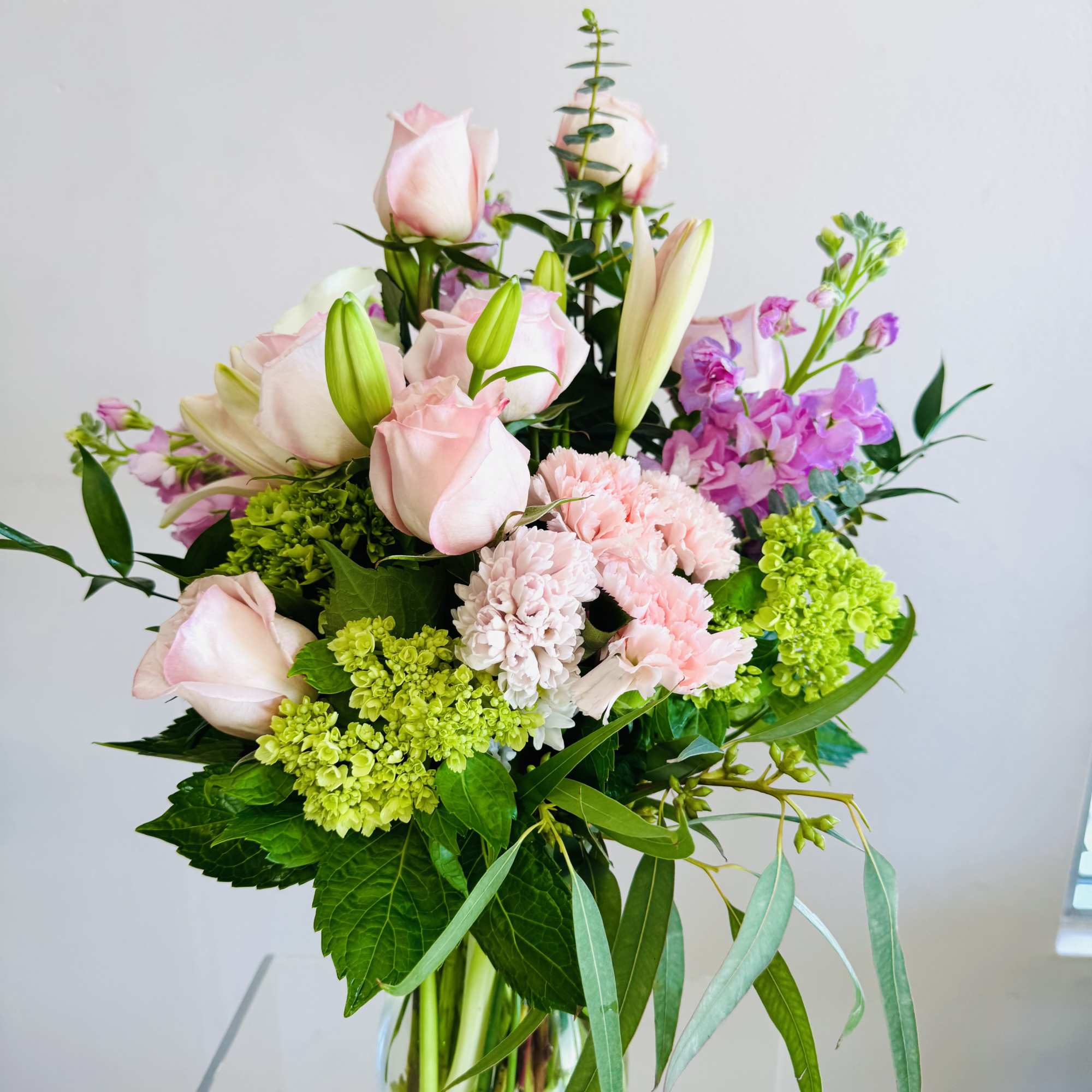 This arrangement is soft, romantic, and fresh with an elegant mix of