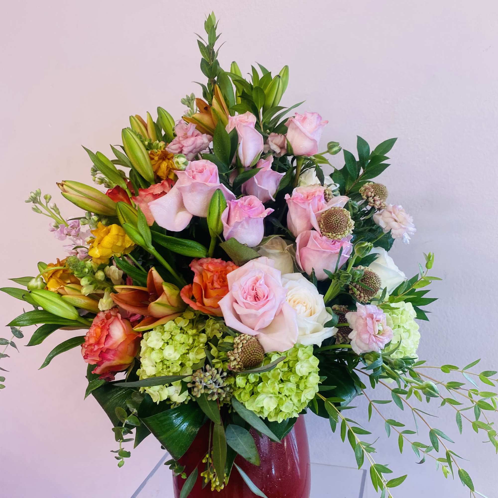 An arrangement full of body, floral and color featuring: 
(9) Pink O'Hara