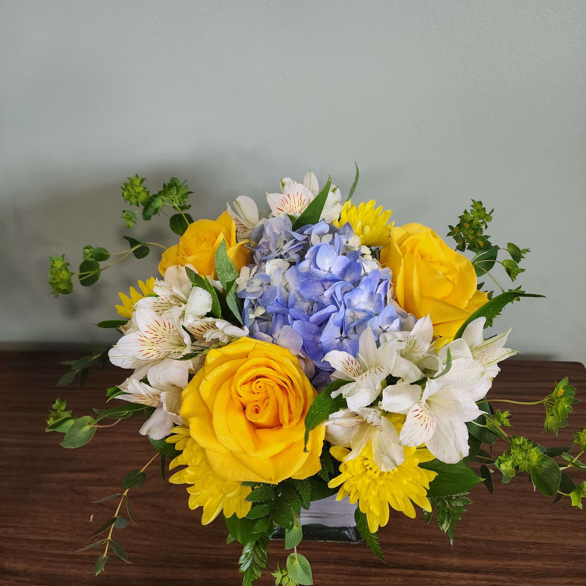 This delightful bouquet is designed in a glass cube with hydrangea, alstroemeria