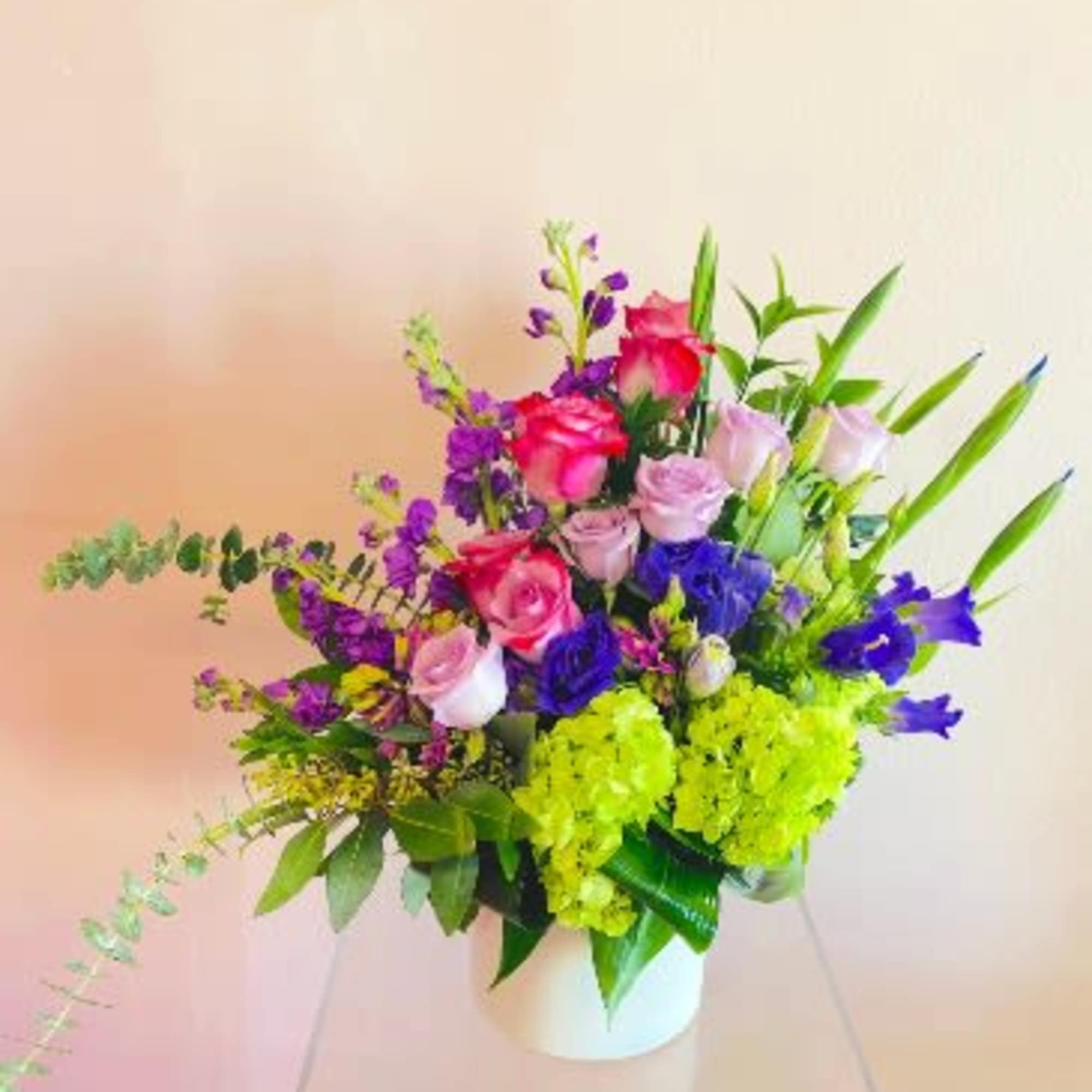 A floral mix of captivating hues. This alluring flower arrangement blooms with
