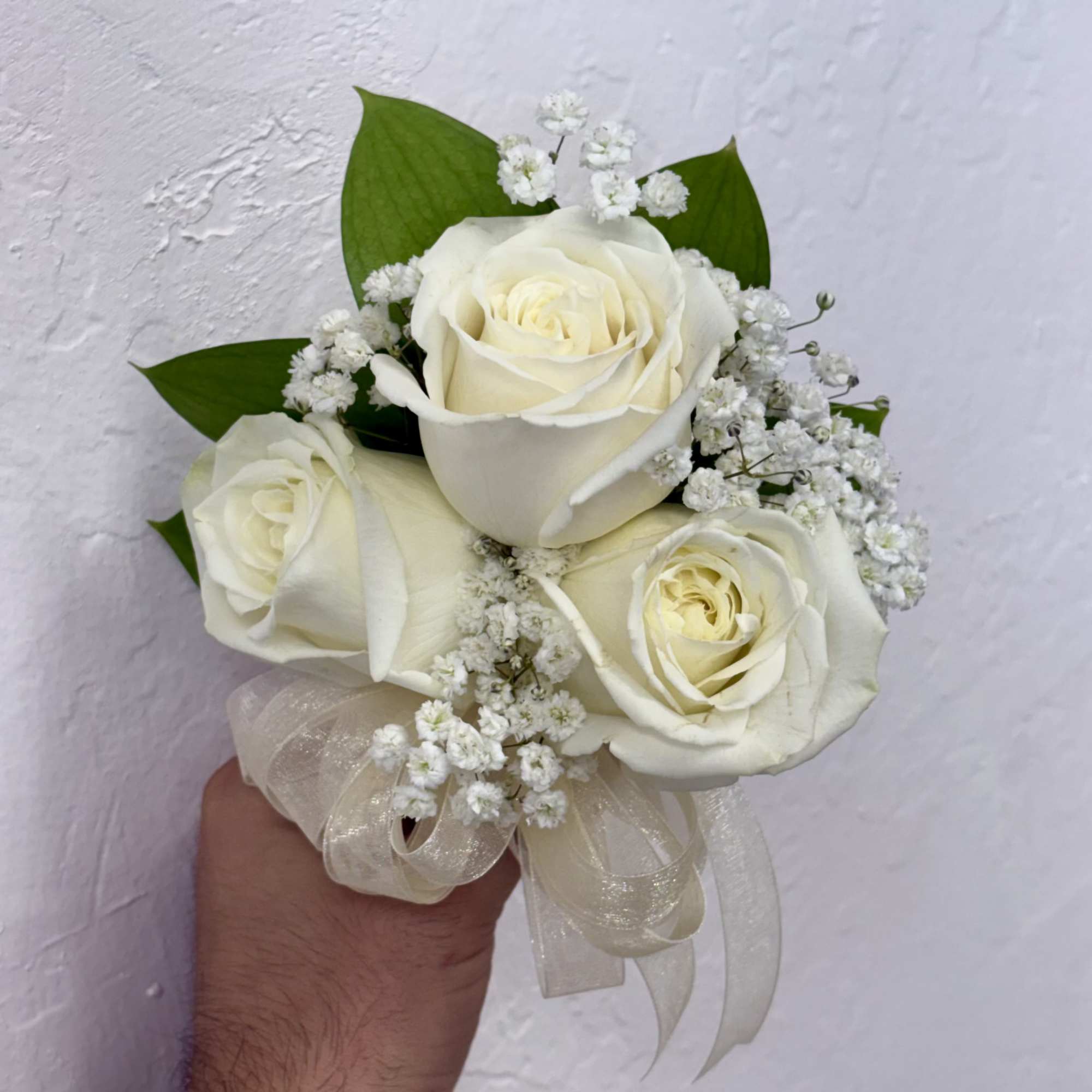 Elegant wrist corsages handcrafted with premium roses and lush foliage. Ideal for