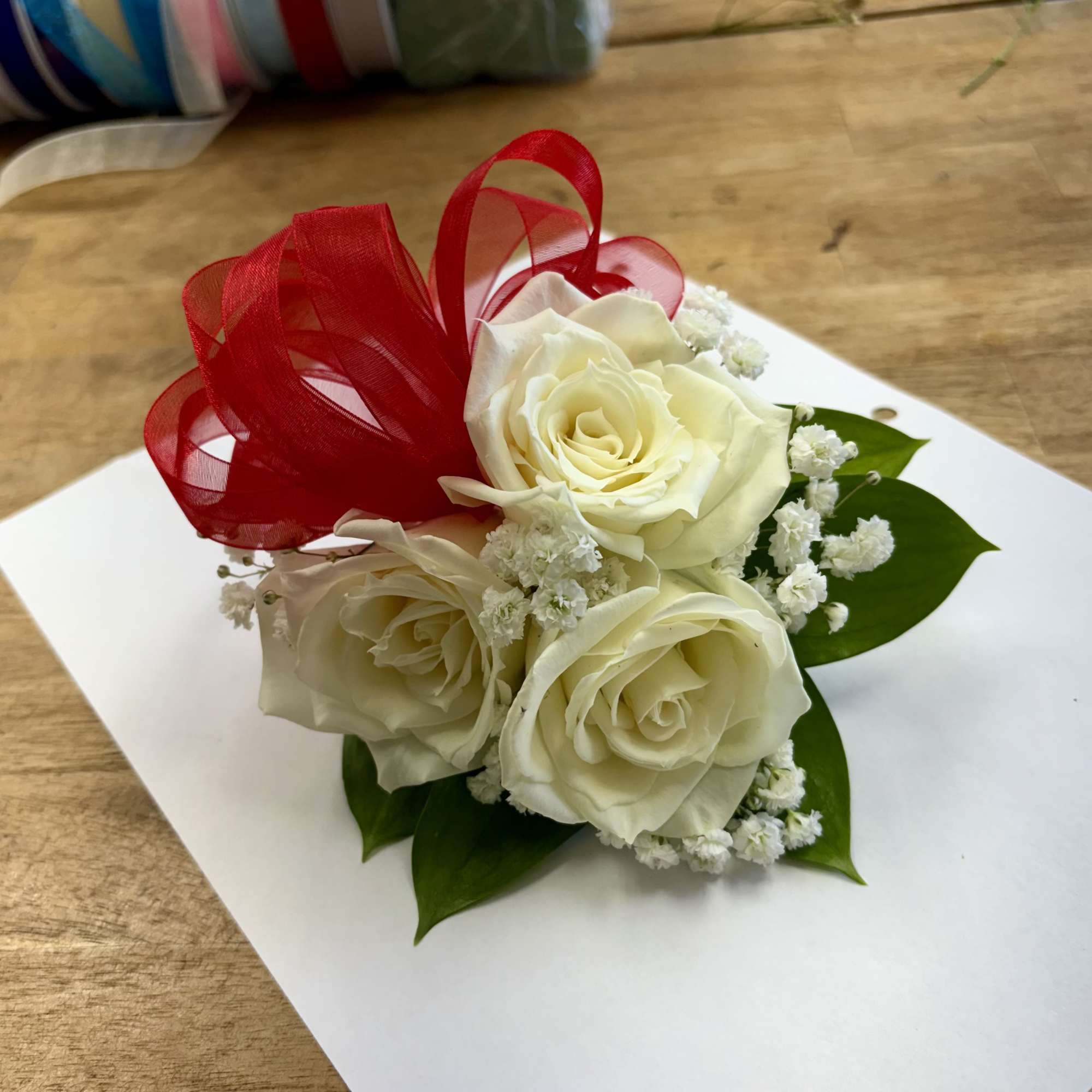 Elegant wrist corsages handcrafted with premium roses and lush foliage. Ideal for
