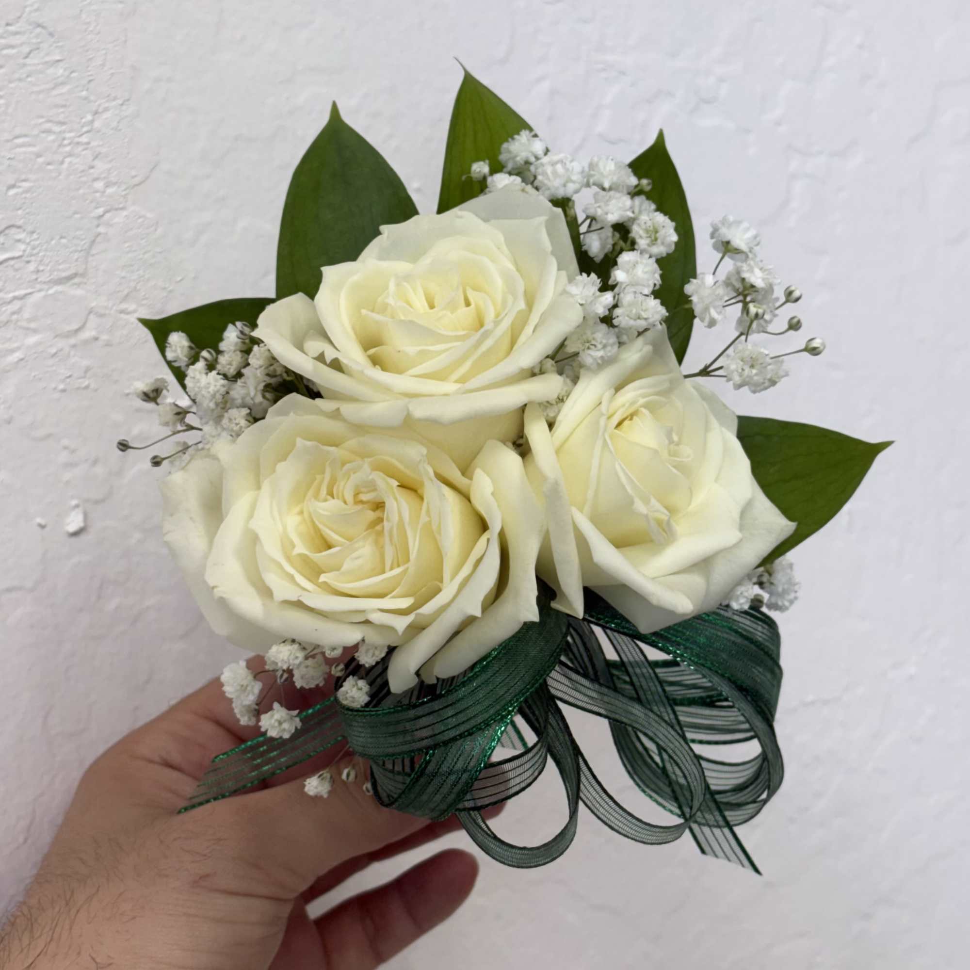 Elegant wrist corsages handcrafted with premium roses and lush foliage. Ideal for