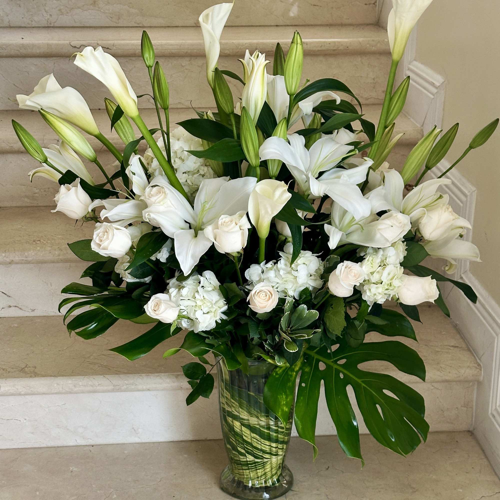 All white premium arrangement with Roses, Lilies, Callas, Hydrangeas and other flowers