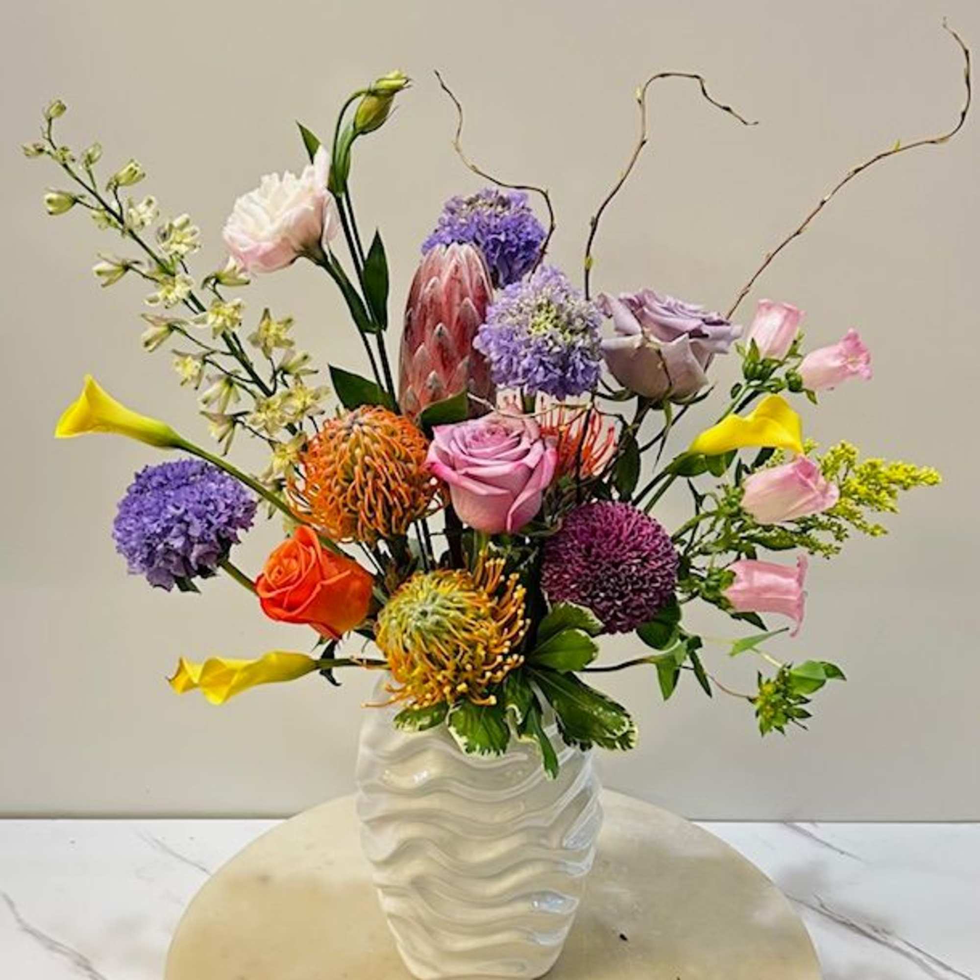 A vibrant and elegant arrangement designed to turn heads. Featuring a bold