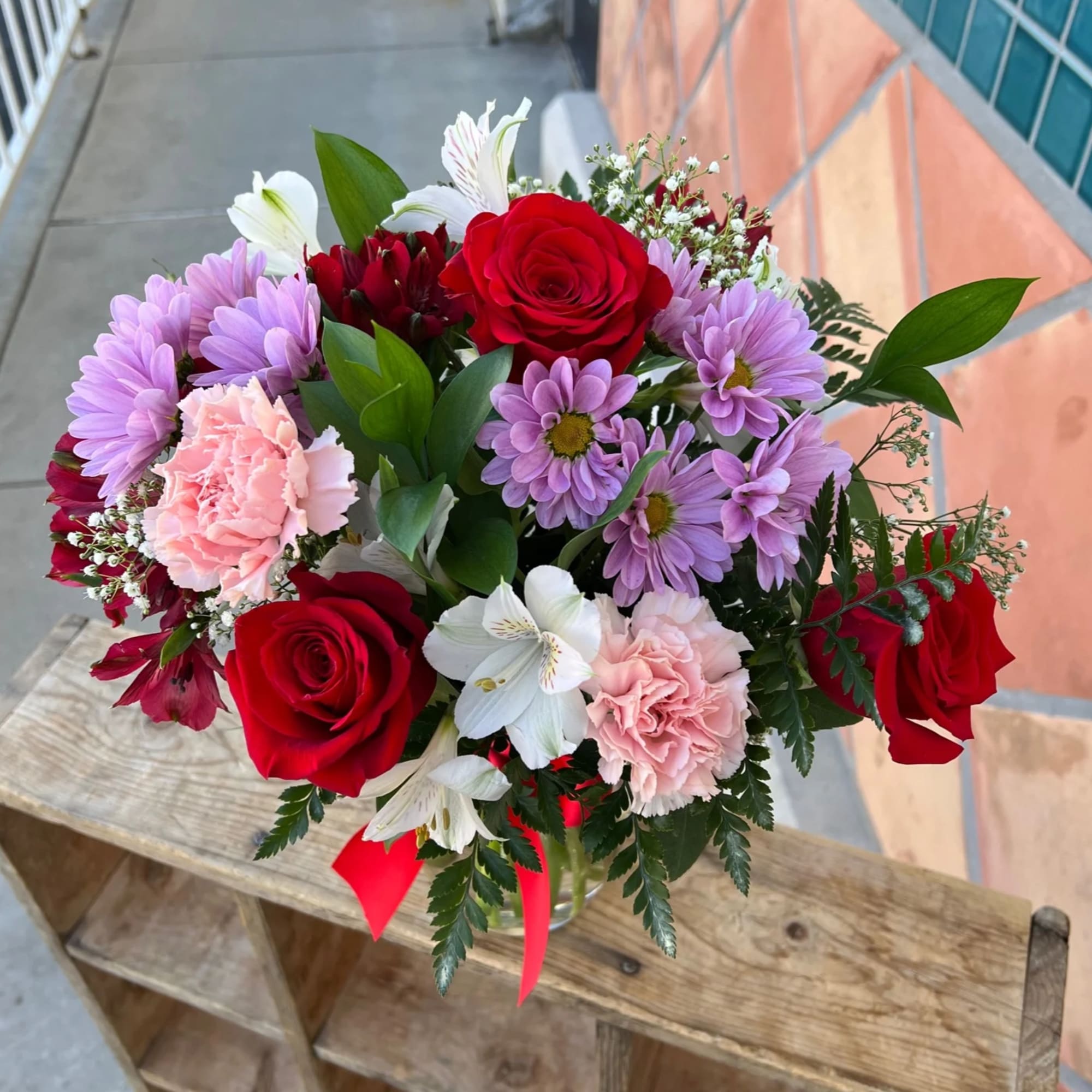 This is a mixed flowers arrangement in red, white, and pink. We