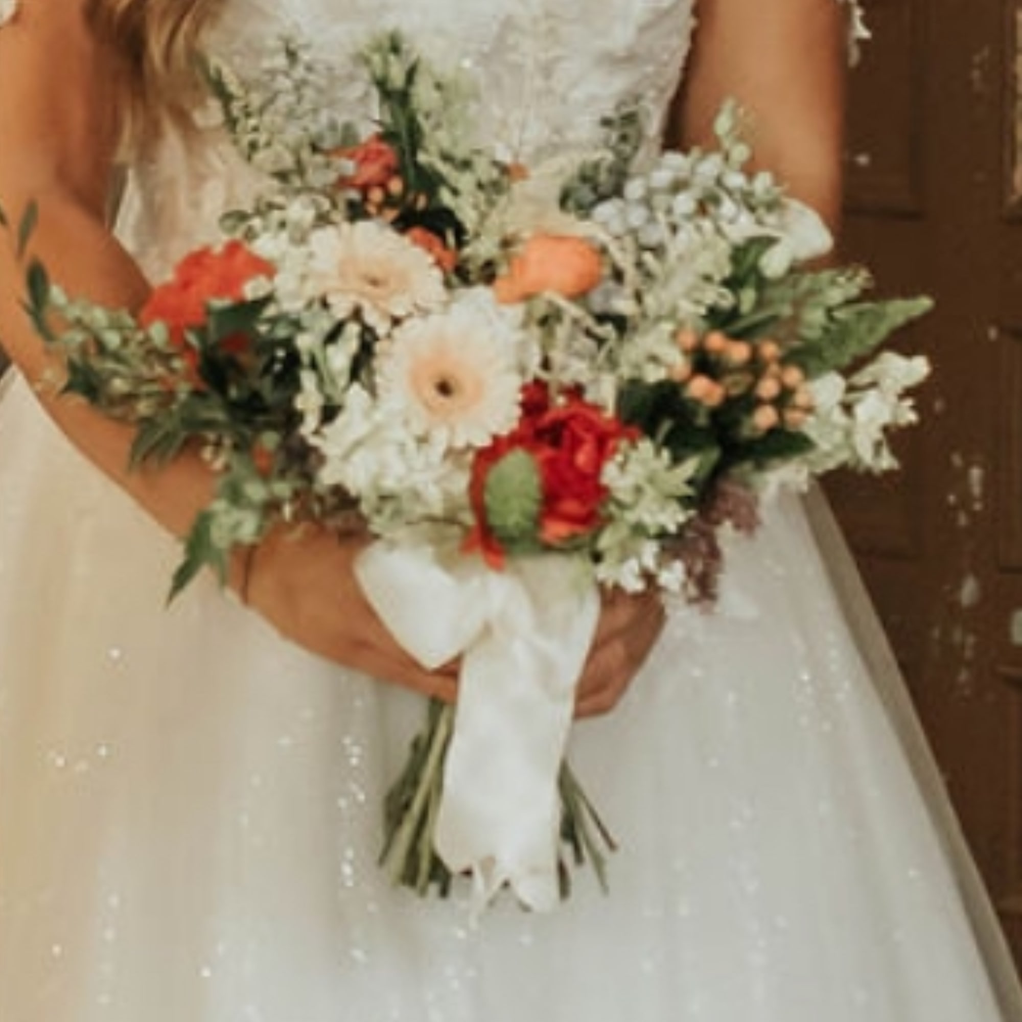 A wedding bouquet that show cases a variety of flowers and optional