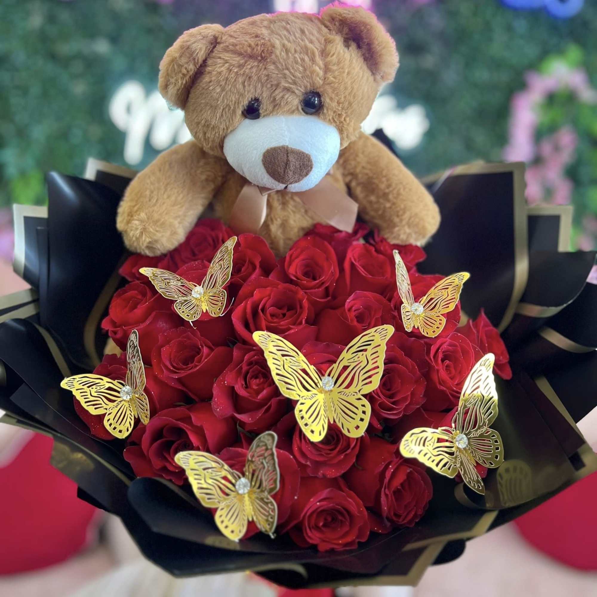 The bouquet is carefully crafted with vibrant, velvety red roses, symbolizing love