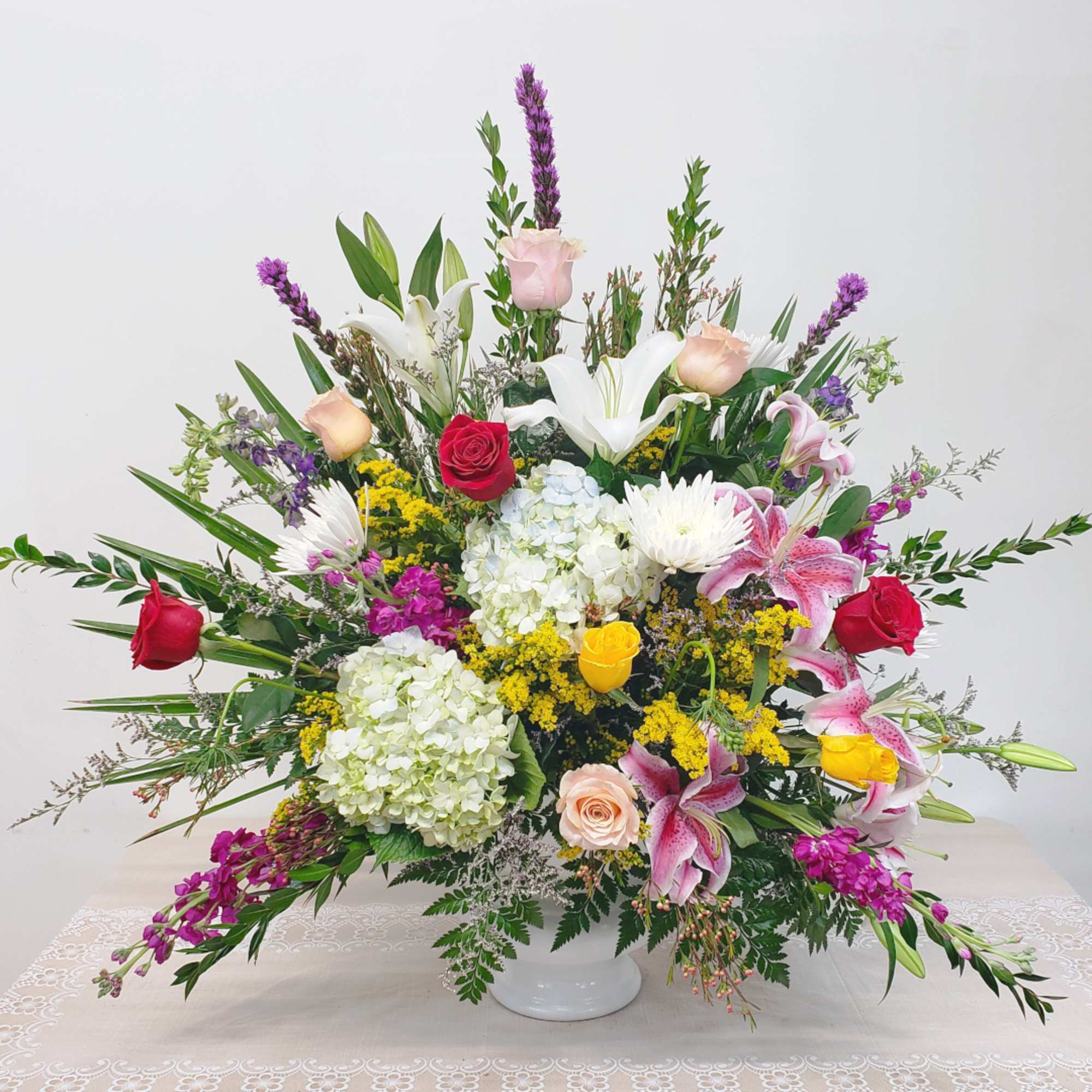 A beautiful, mixed-color funeral arrangement will be created with the artistry and