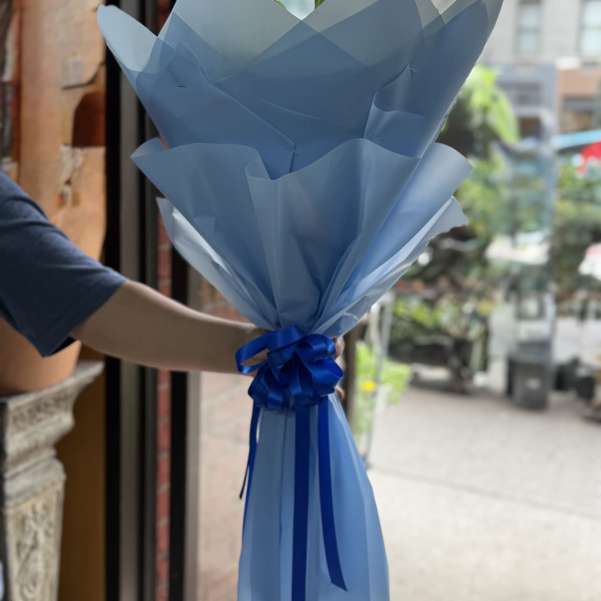 This beautiful all around loose bouquet of blue, green and white is