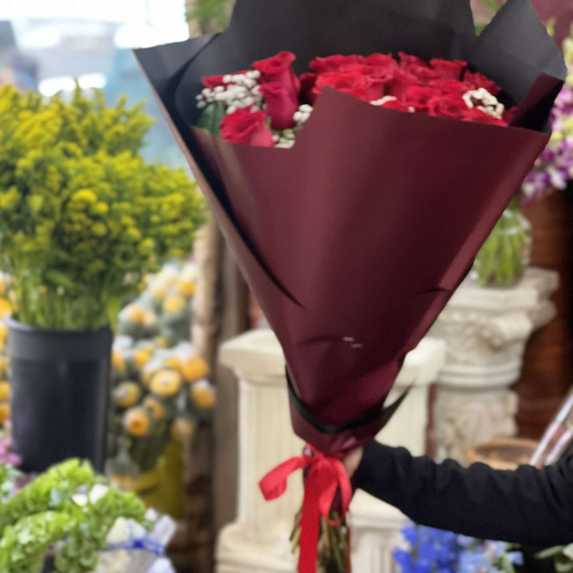 This loose bouquet of two dozen long stemmed roses is sure to