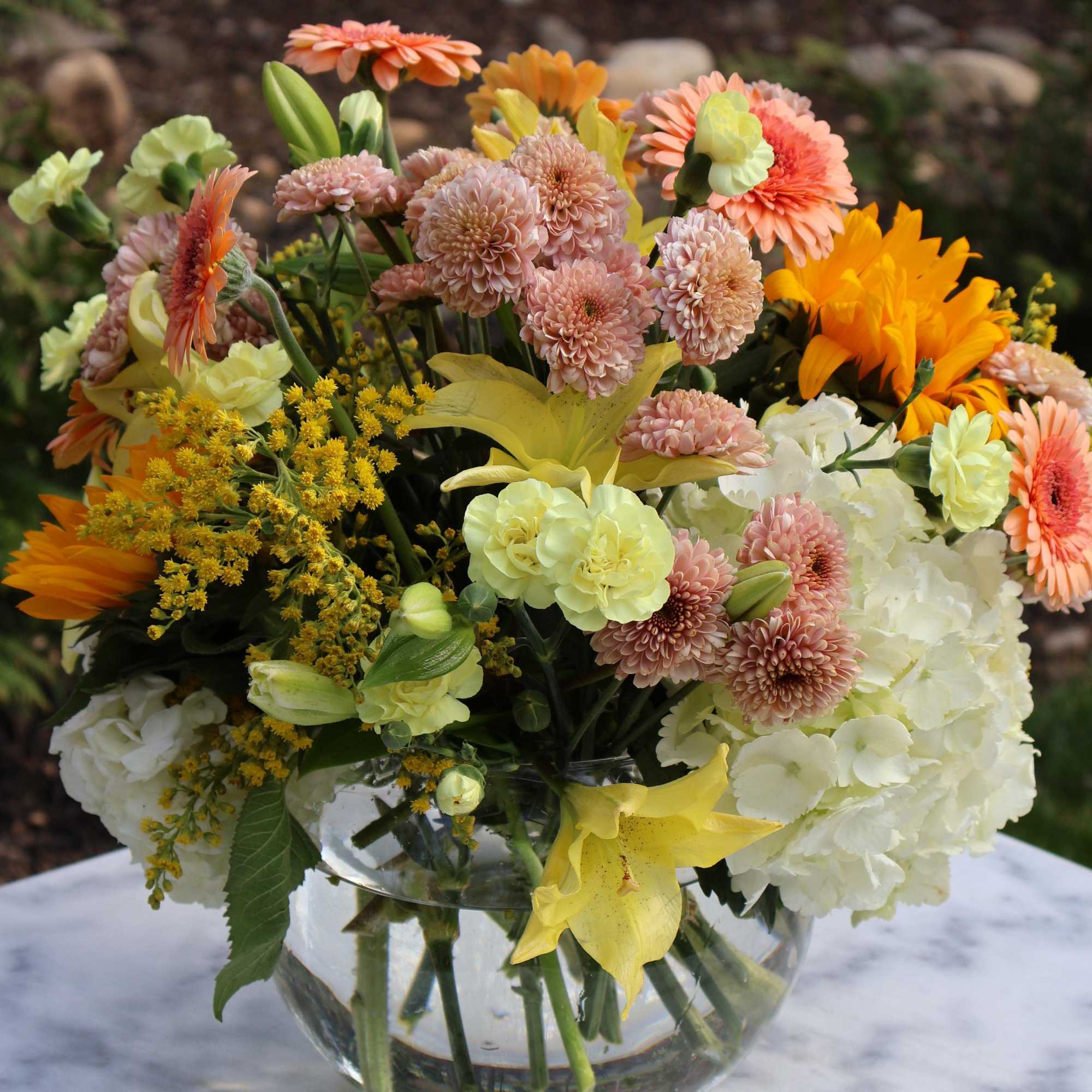&ldquo;Golden Morning&rdquo; is a cheerful and lush floral arrangement that blends soft