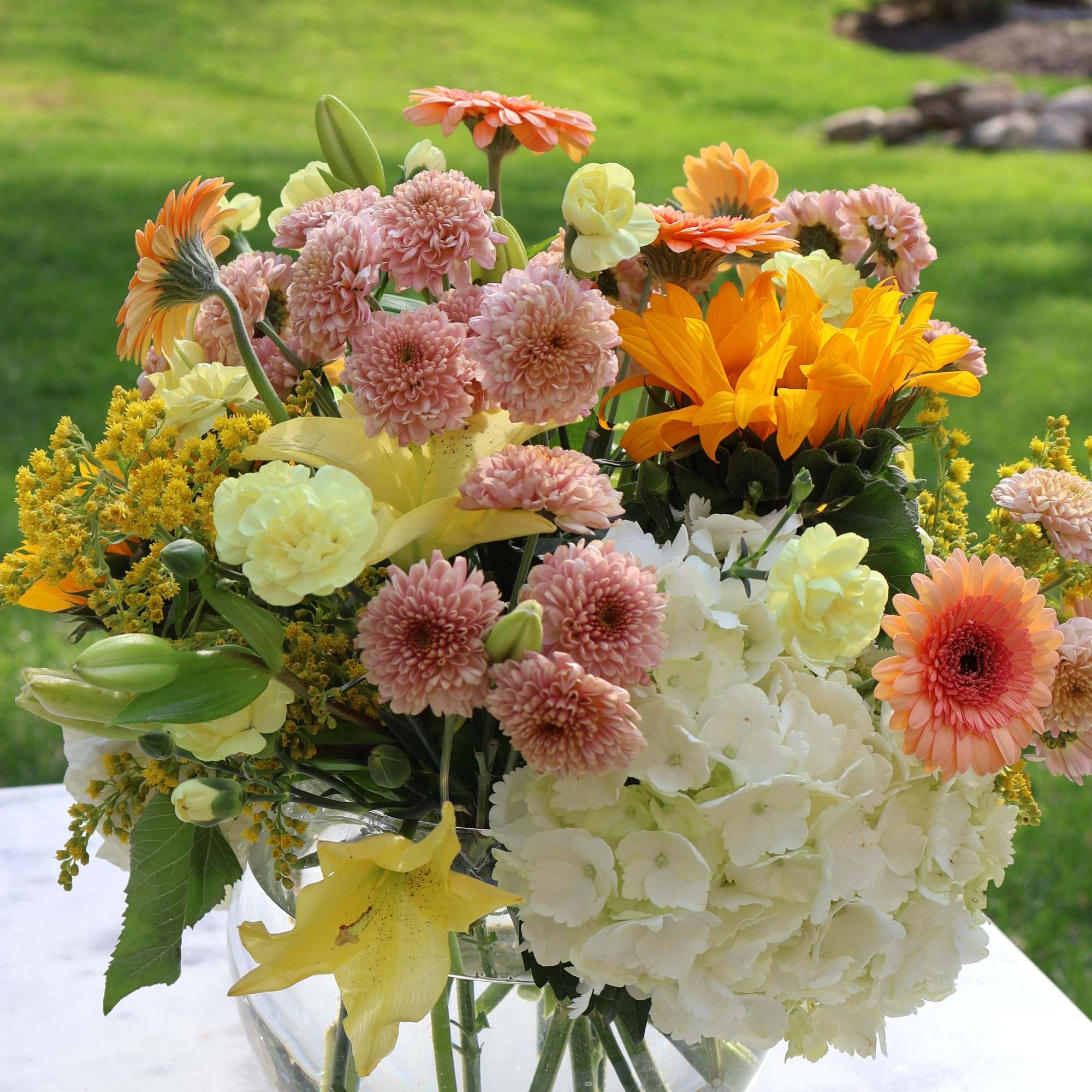 &ldquo;Golden Morning&rdquo; is a cheerful and lush floral arrangement that blends soft