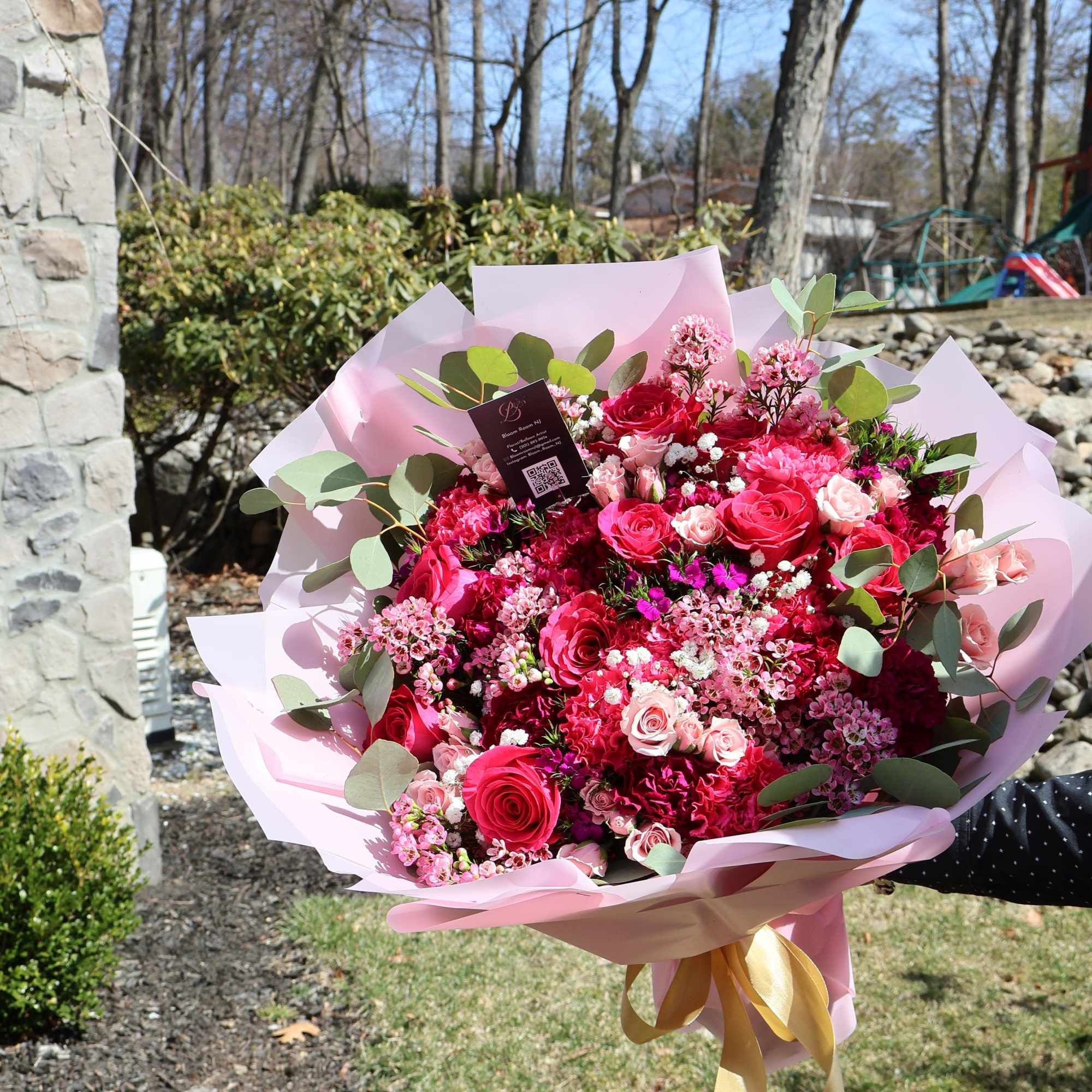 A romantic harmony of roses, carnations, and delicate filler flowers in shades