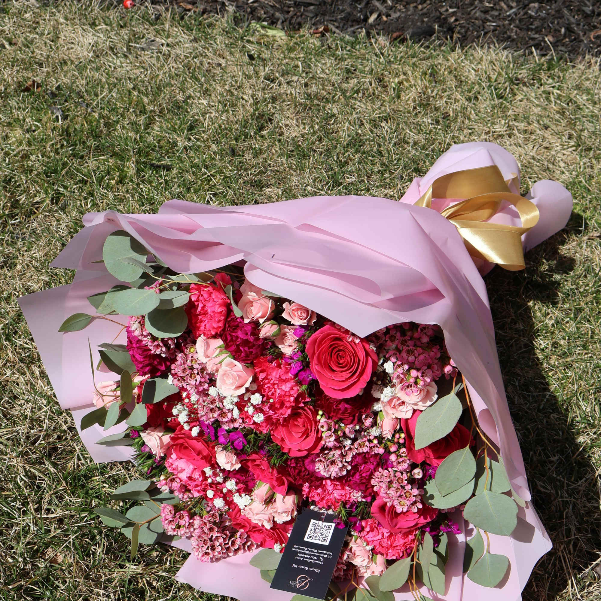 A romantic harmony of roses, carnations, and delicate filler flowers in shades