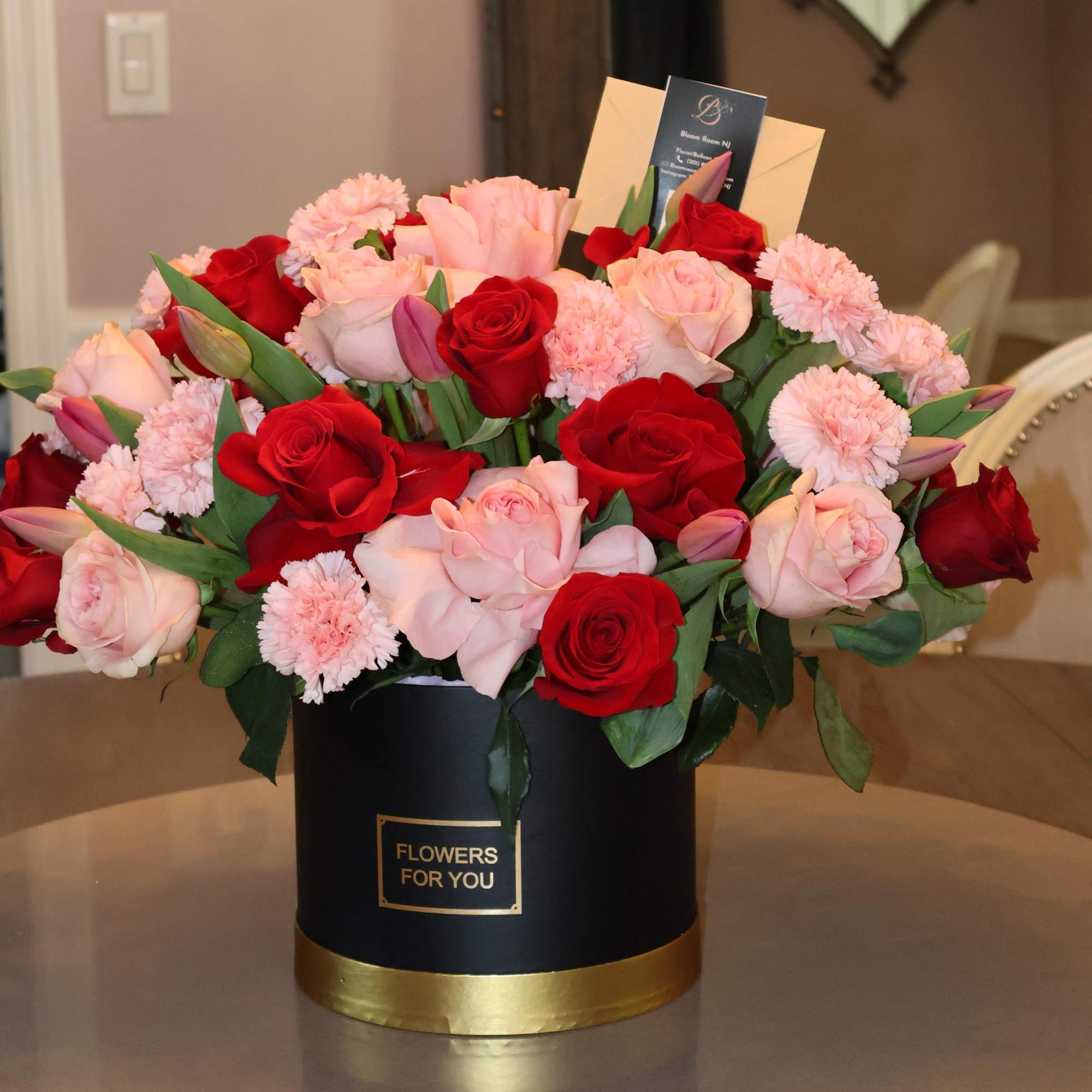 A luxurious floral arrangement featuring a romantic blend of deep red and
