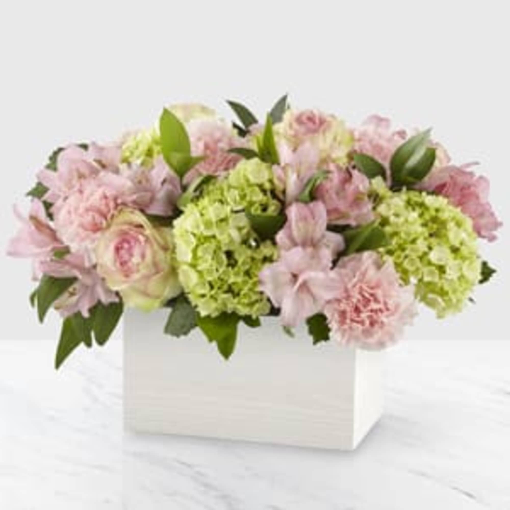 The true beauty in this arrangement is in the soft hues, sweet