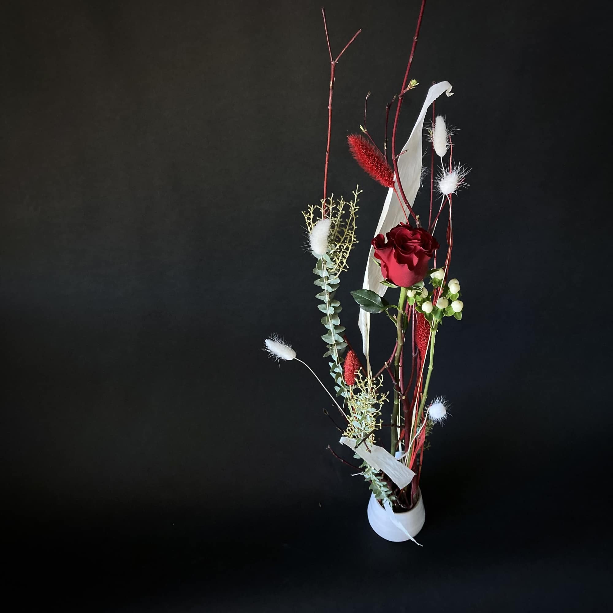 Red rose presented in a vase in a contemporary and dynamic way.