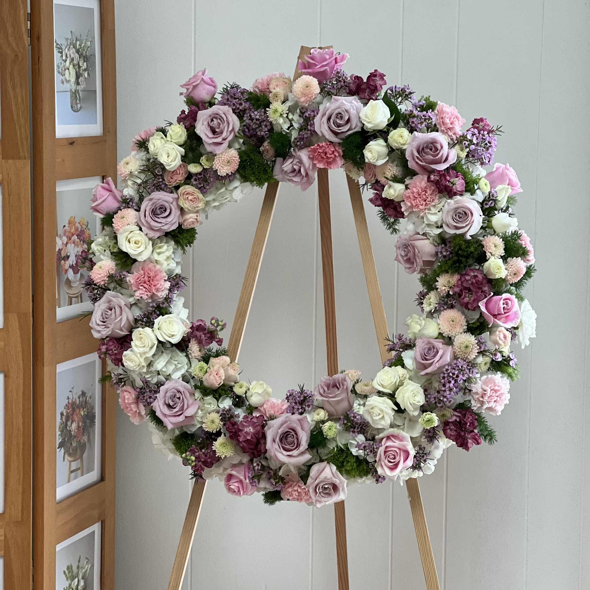 The Pink Wreath is a gorgeous and soft standing spray arrangement delivered