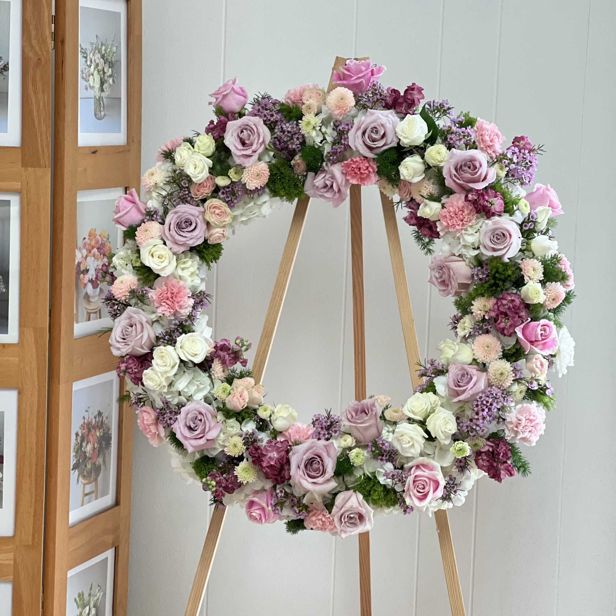 The Pink Wreath is a gorgeous and soft standing spray arrangement delivered