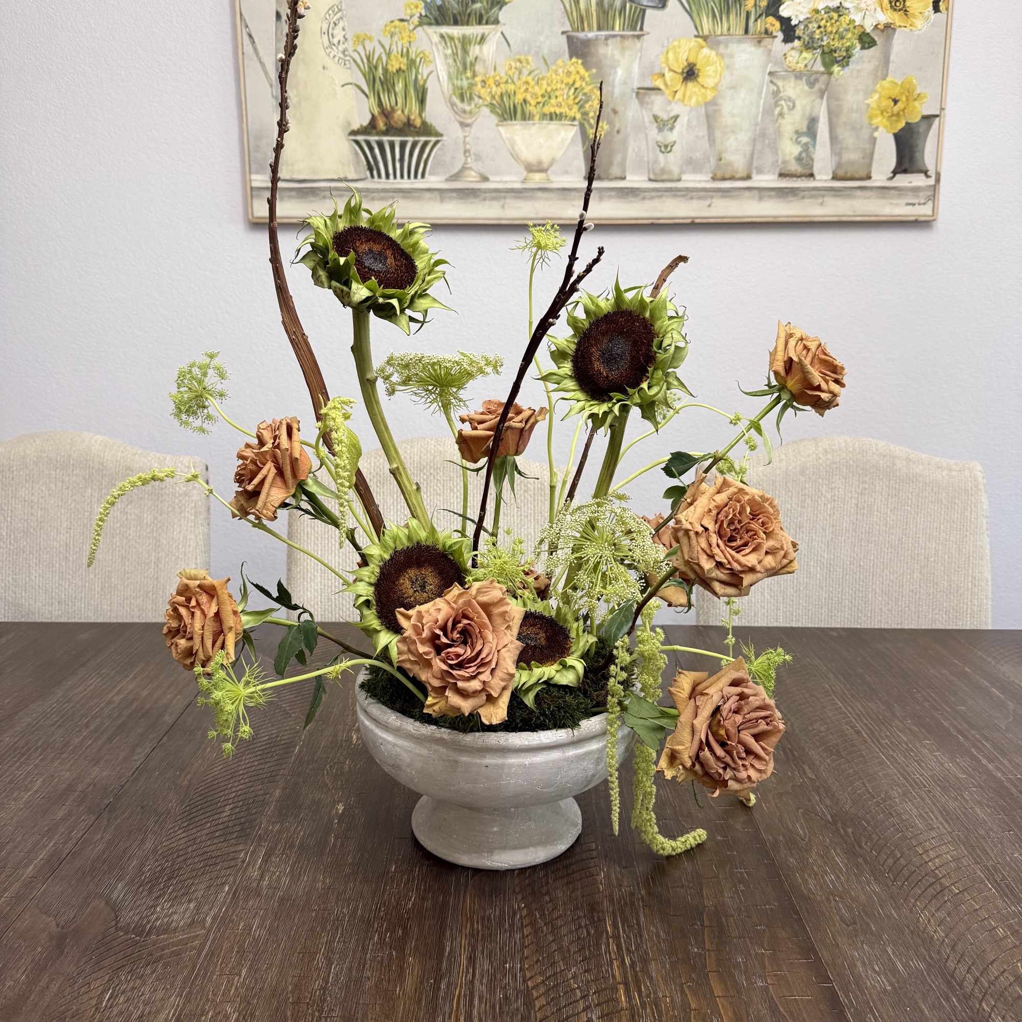 Toffee roses, sunflowers and hanging amaranthus in a ceramic container