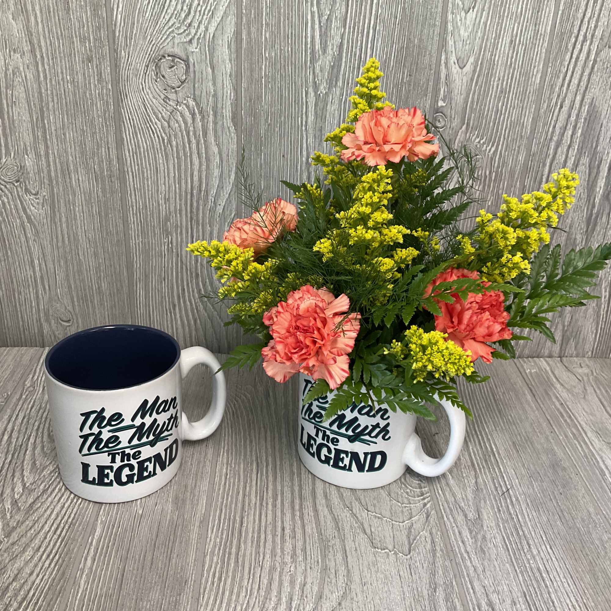 Fresh cut flowers in a keepsake ceramic mug. Flowers and colors may Fresh cut flowers in a keepsake ceramic mug. Flowers and colors may