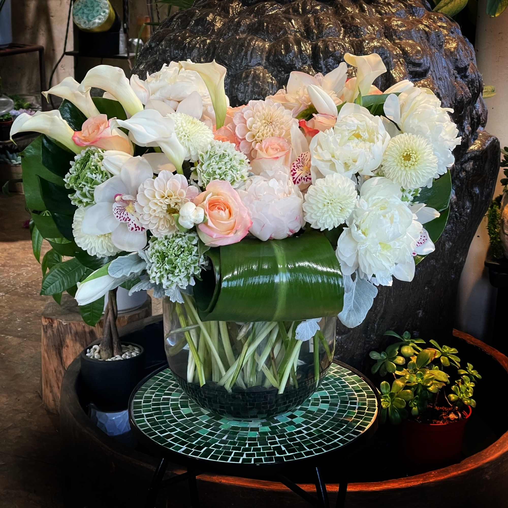 Peonies, Cymbidium Orchid, Ranunculus, Lisianthus, Calla Lilies, Roses,.. and greenery in glass
