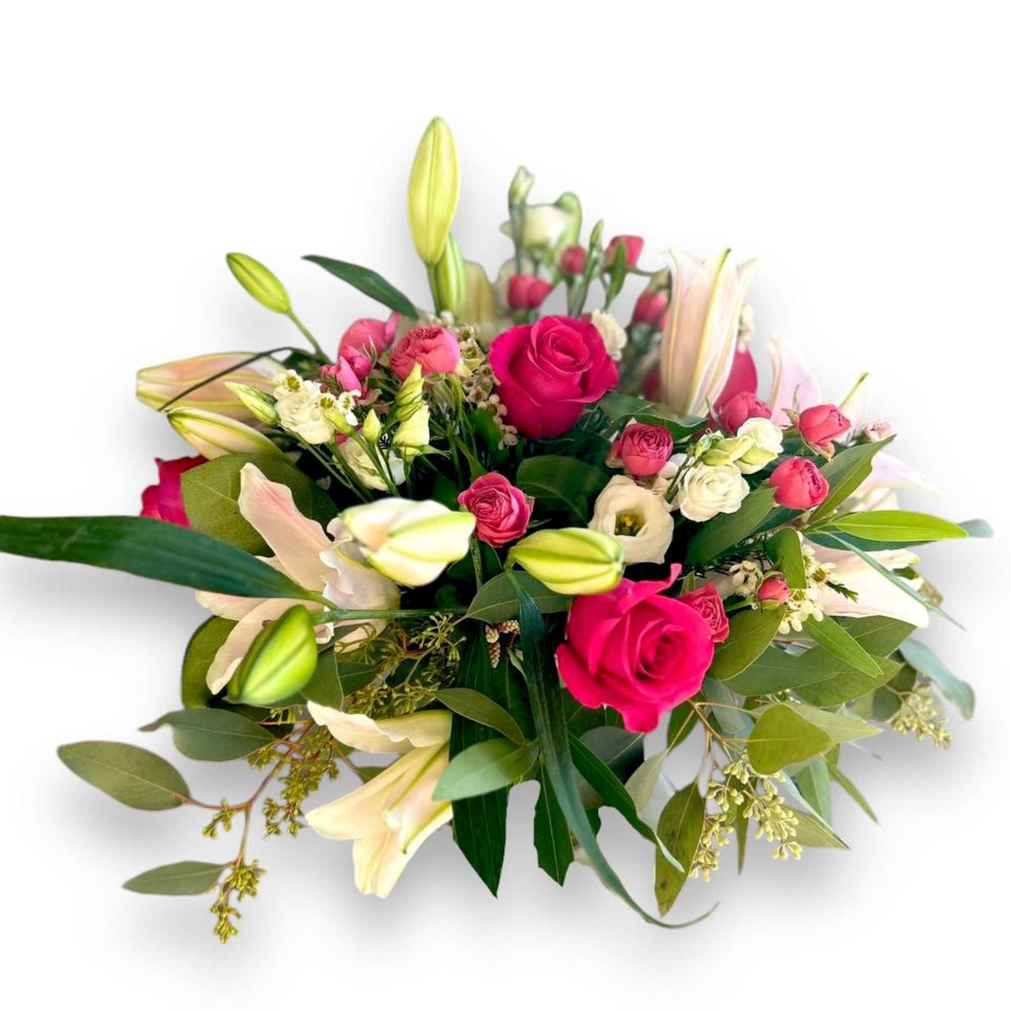 This gorgeous centerpiece showcases hot pink roses, light pink lilies and white