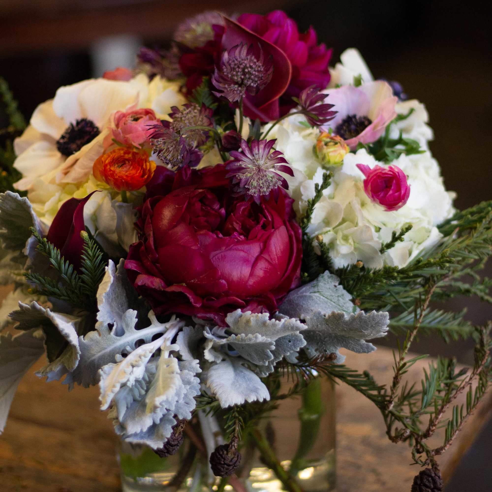 A lush arrangement with rose and plum colored flowers.  A lush arrangement with rose and plum colored flowers.