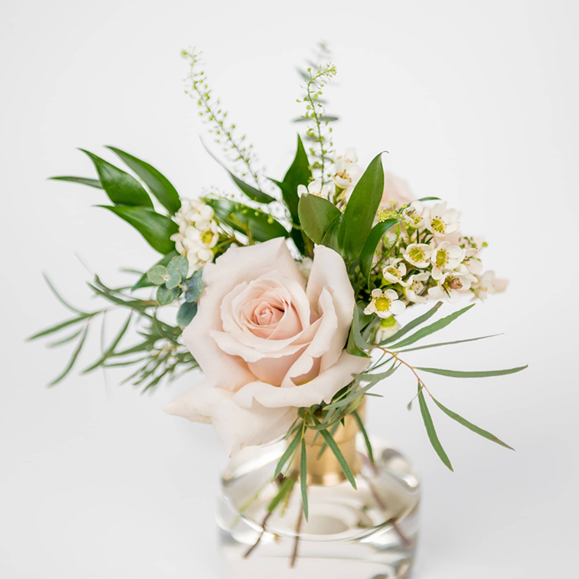 A classic yet modern set of glass bud vases with a brass
