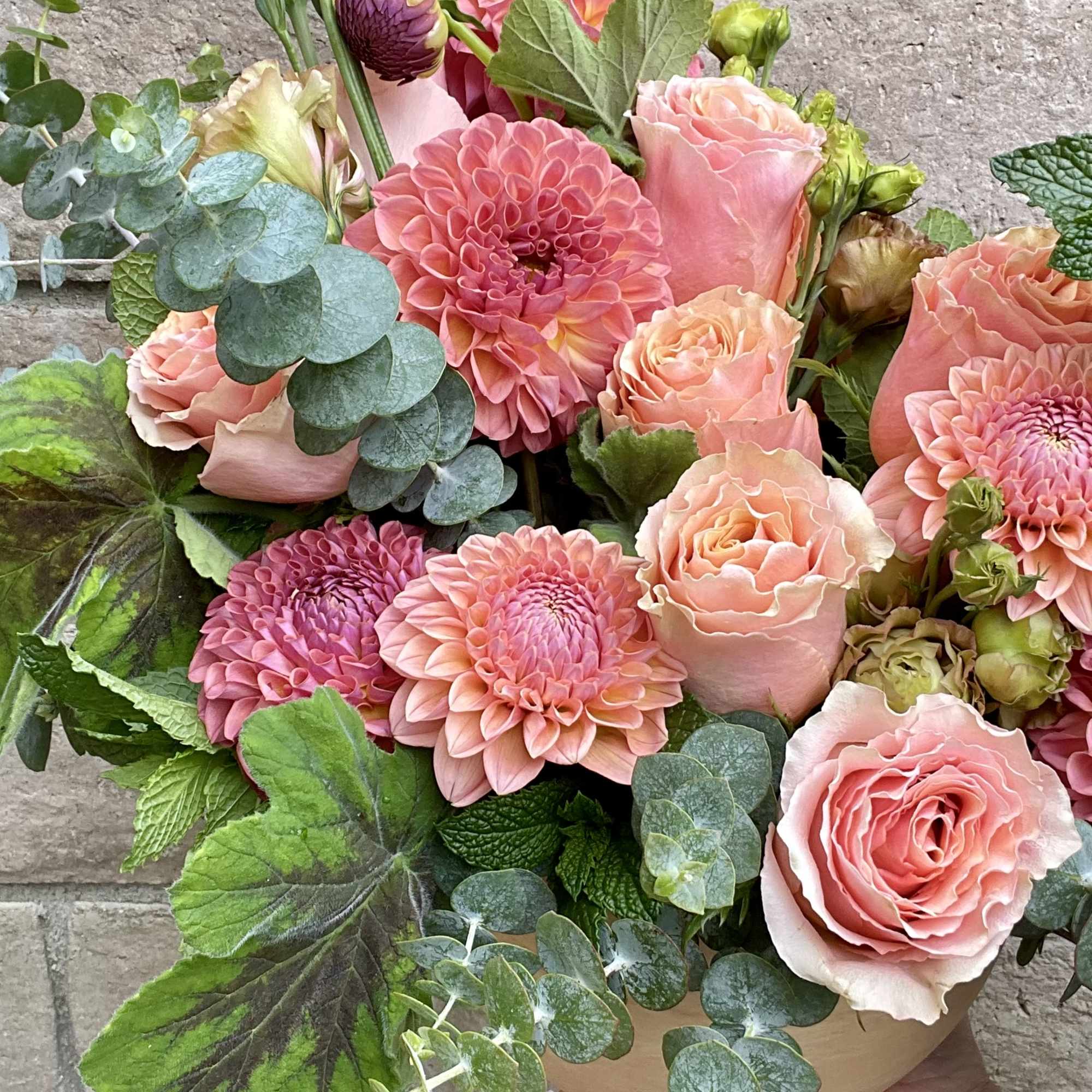 A divine monochromatic arrangement of peach and light coral toned Dahlias and