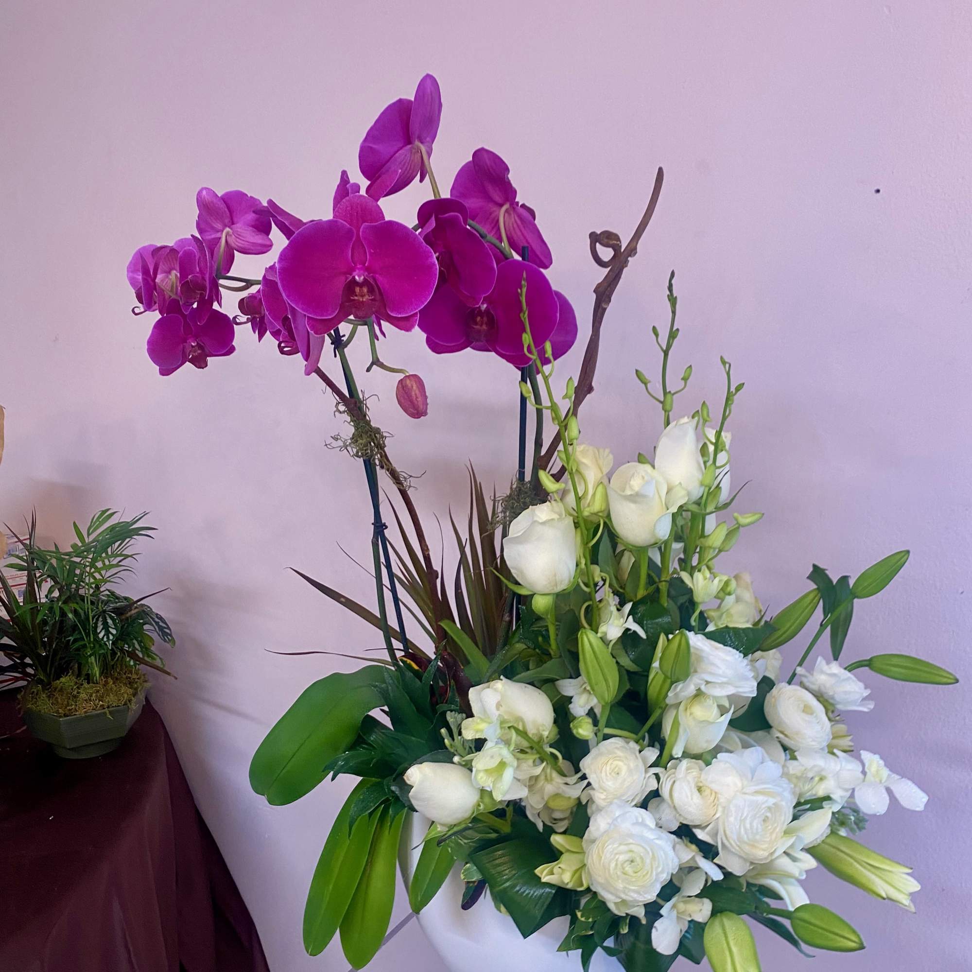 2 large fuchsia orchid blooming plants and a medley of florals such