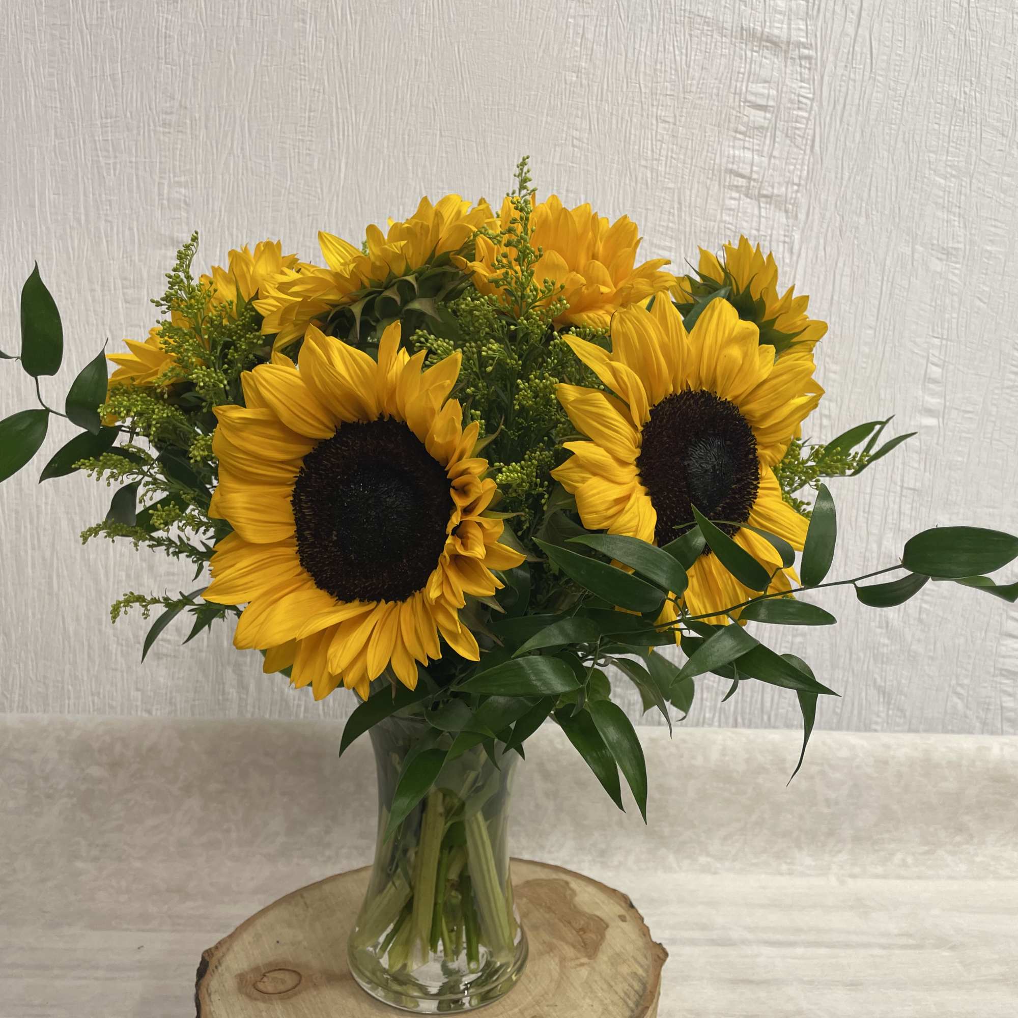 A beautiful cheery vase of all Sunflowers is the perfect way to