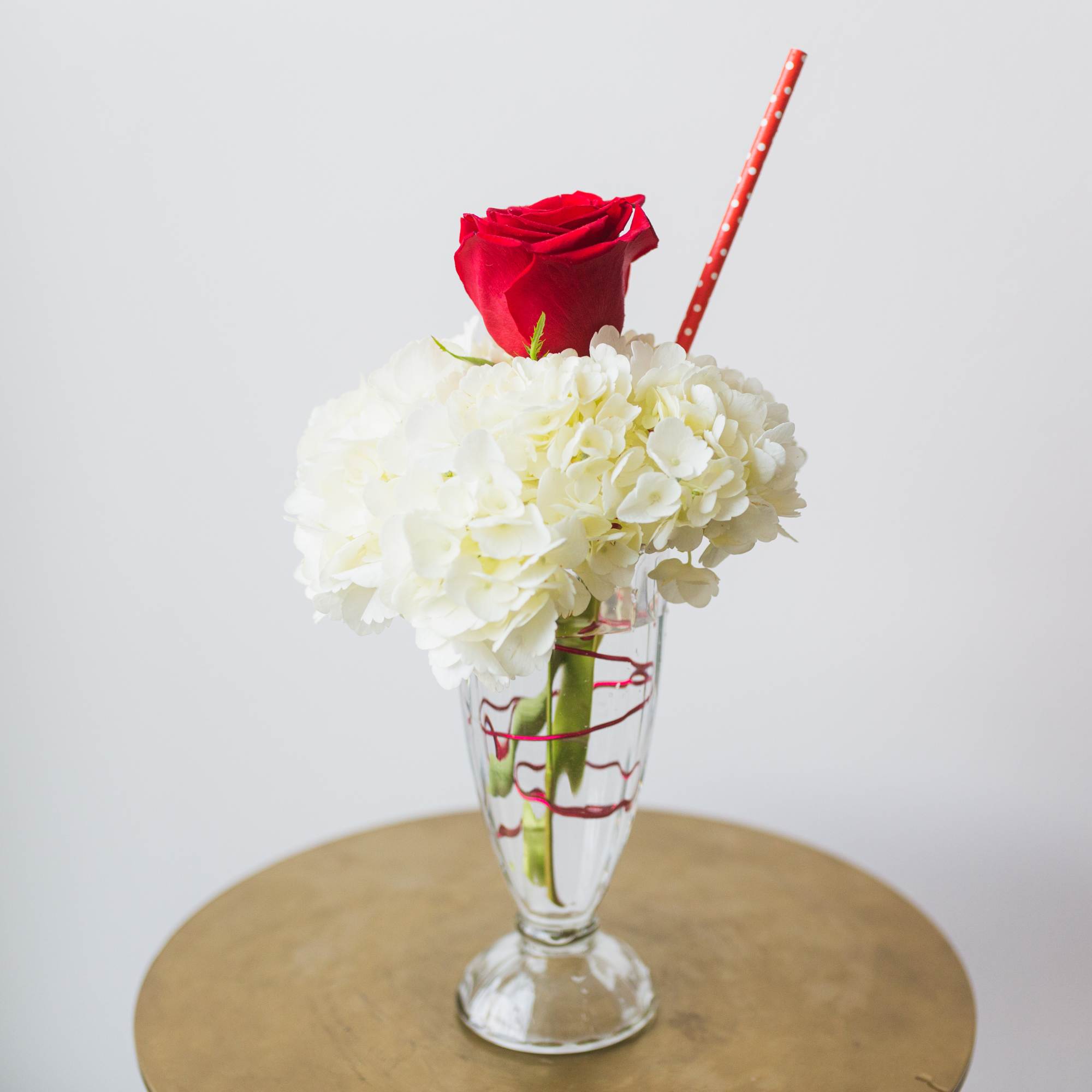 A hydrangea and rose in a soda glass, a floral replica of A hydrangea and rose in a soda glass, a floral replica of