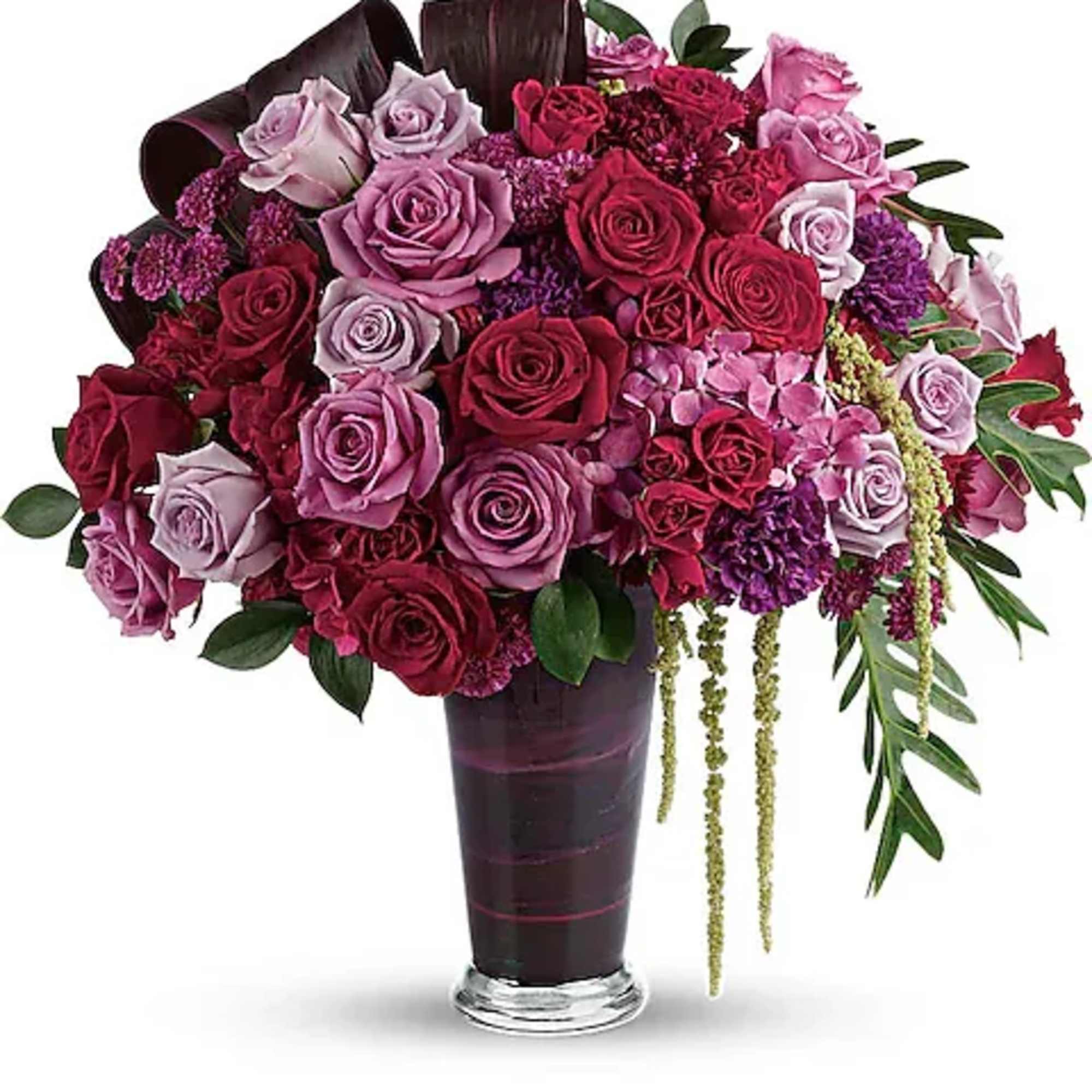 A dramatic display in jewel-toned roses and hydrangea in a sophisticated vase