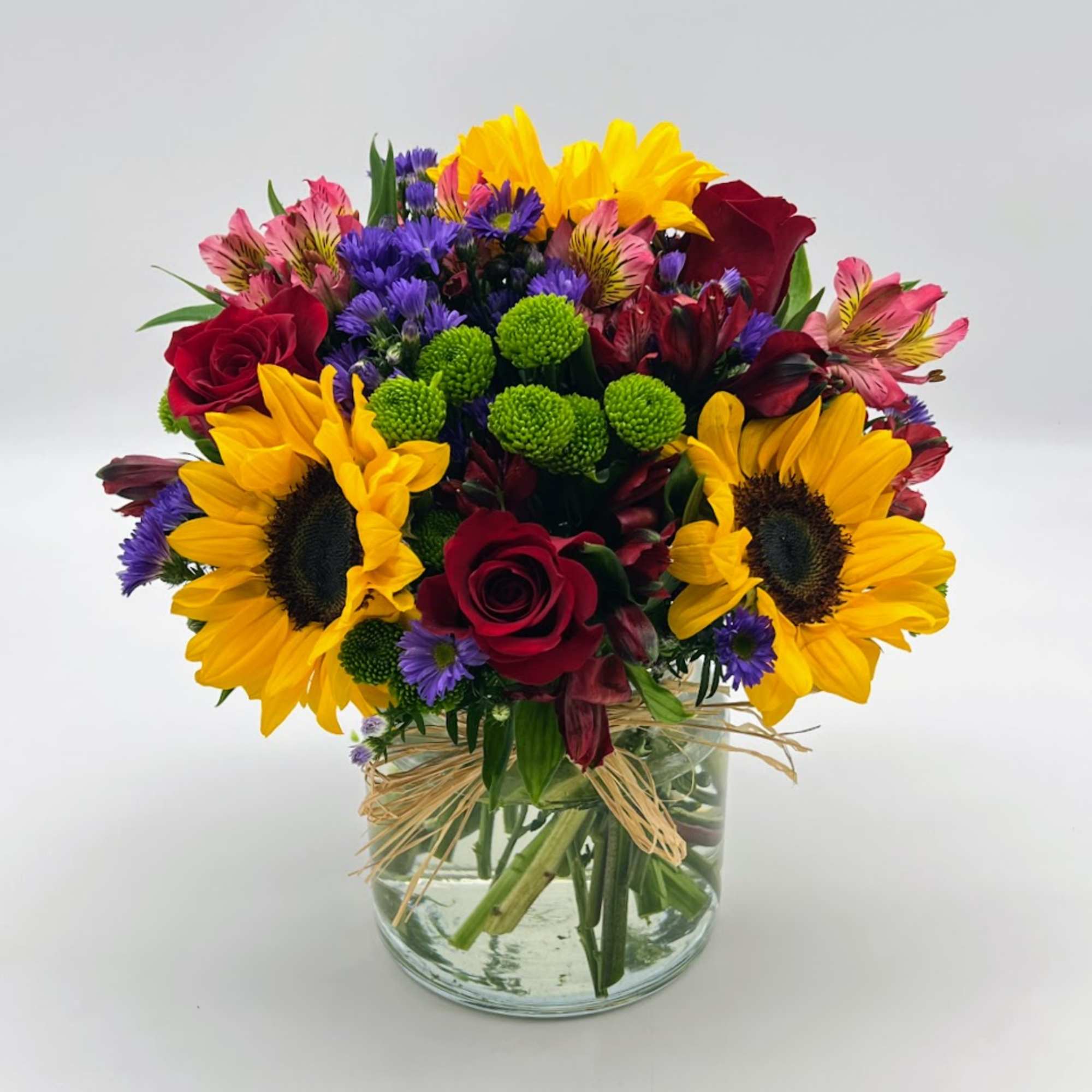 Reminiscent of strolling through a field of flowers, this colorful arrangement captures Reminiscent of strolling through a field of flowers, this colorful arrangement captures