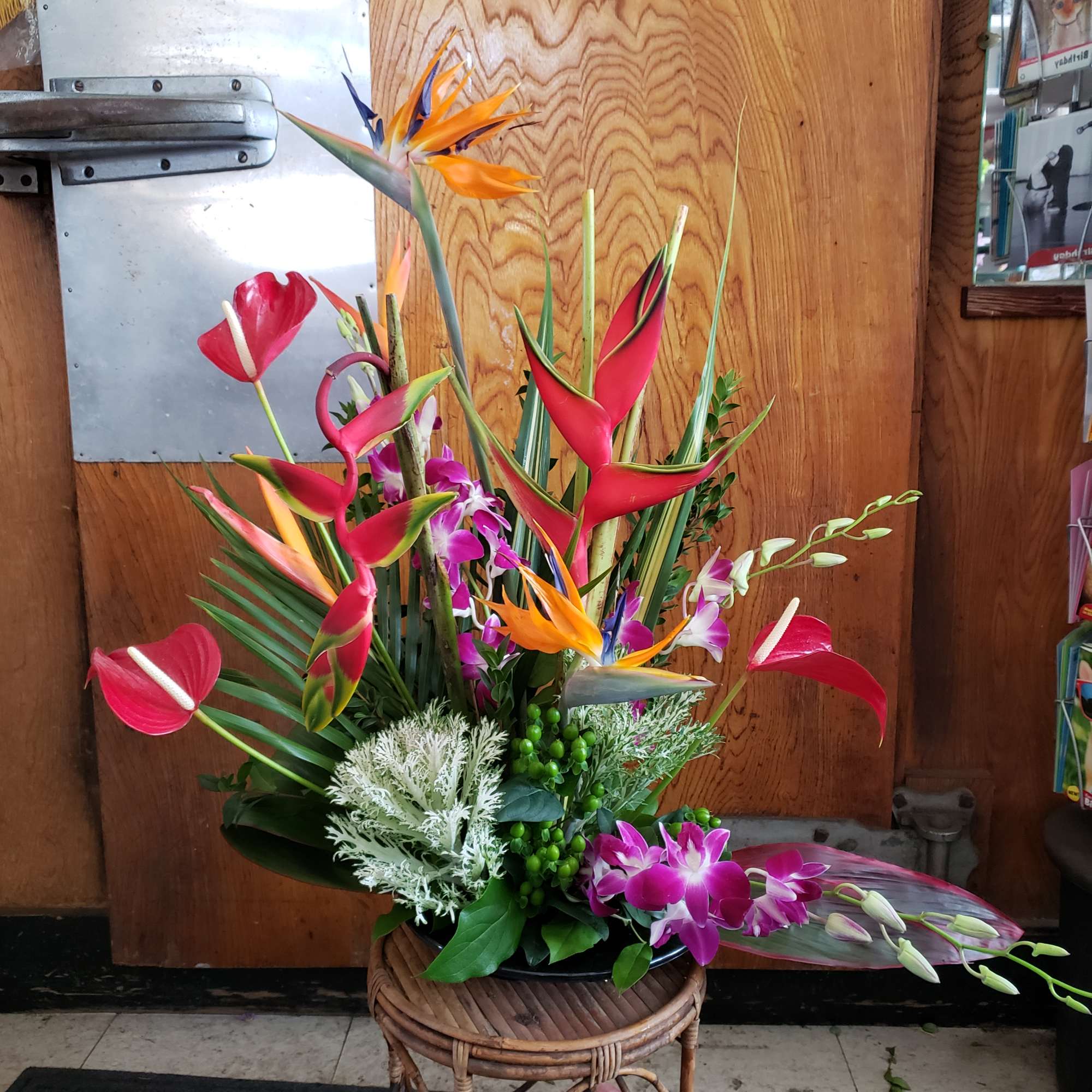 This stunning presentation piece features Hawaiian anthurium and Birds of paradise, complimented