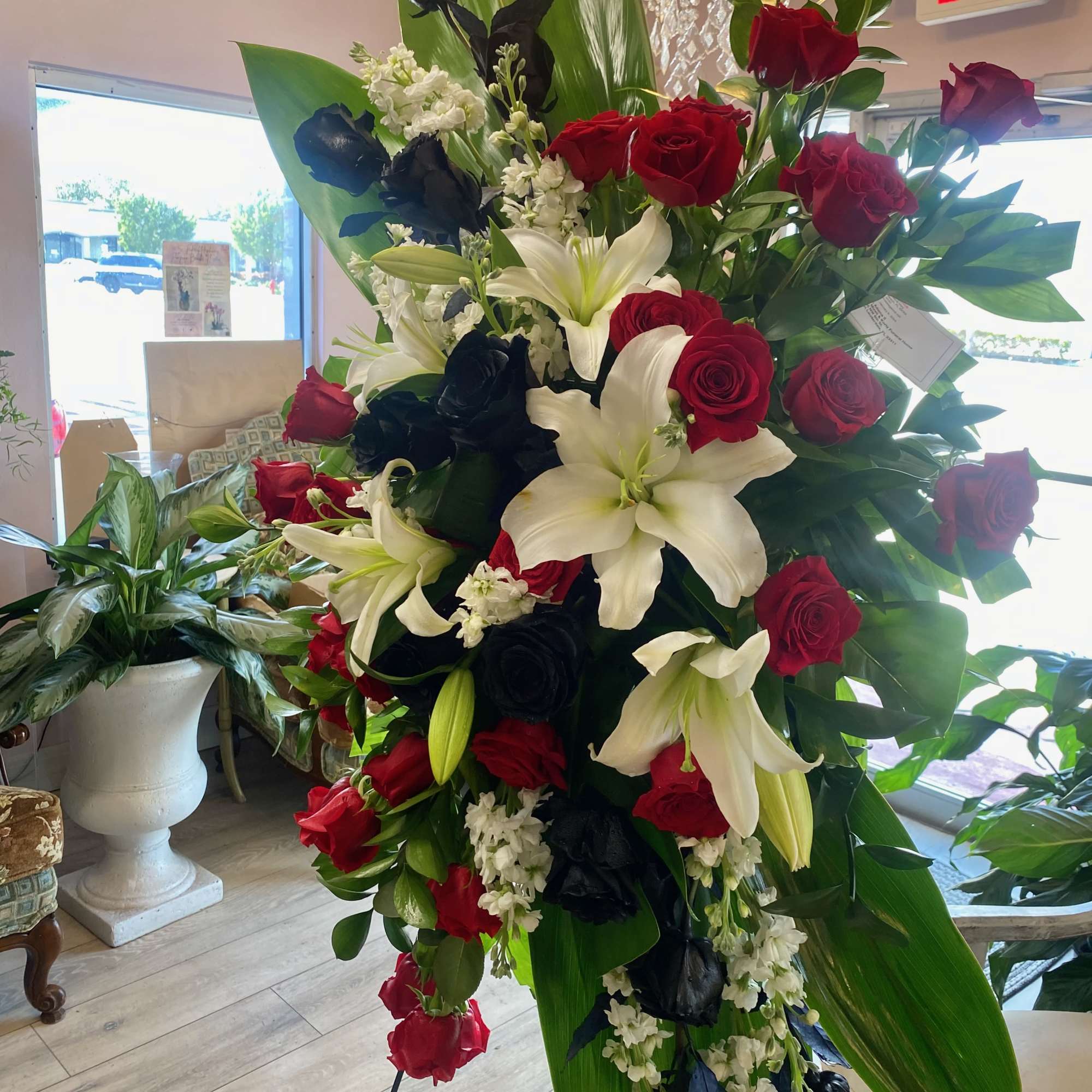 This is a classic spray. Red and black roses, and white lilies